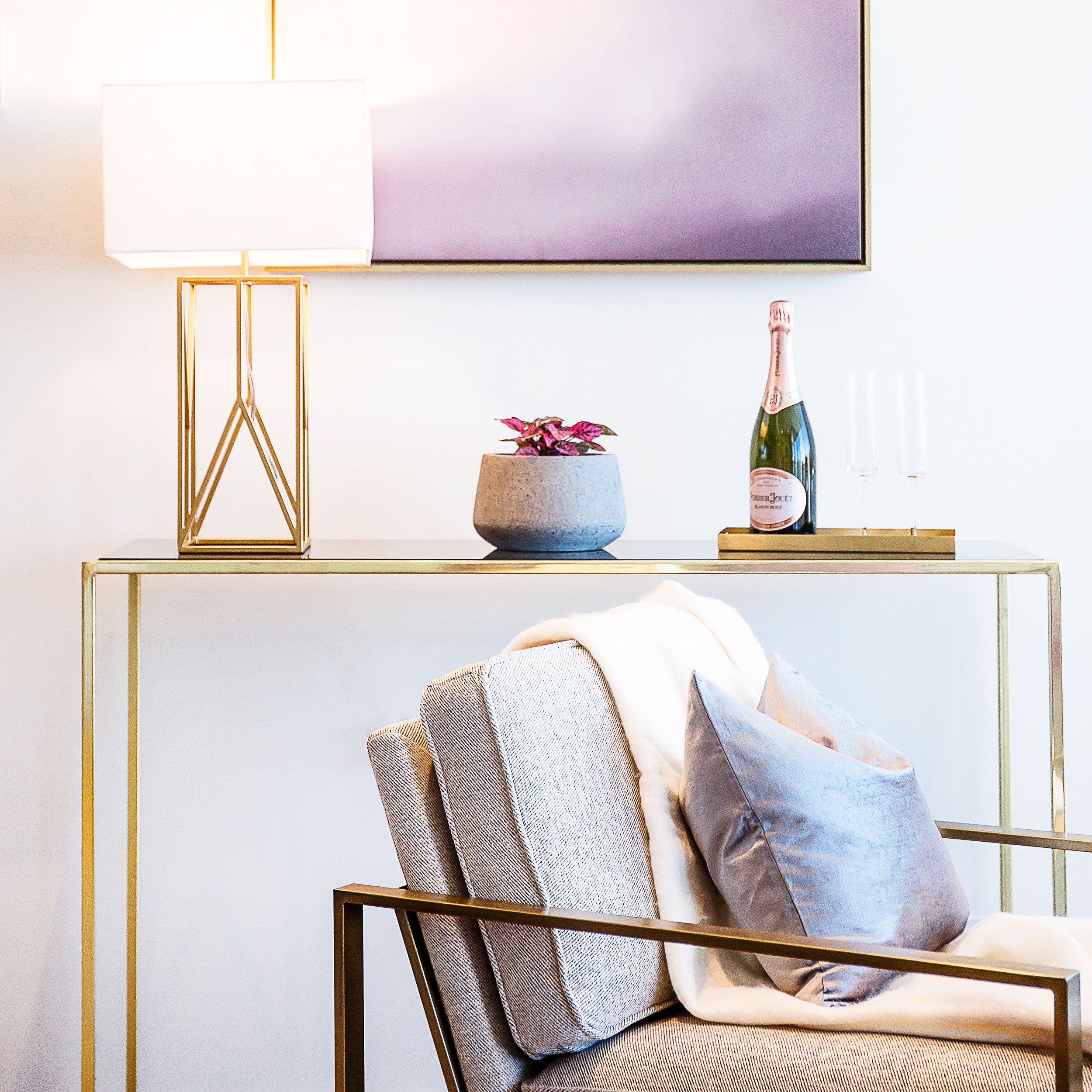 Console table styling with lamp and decorative objects in apartment 1057 at Forge Docklands.