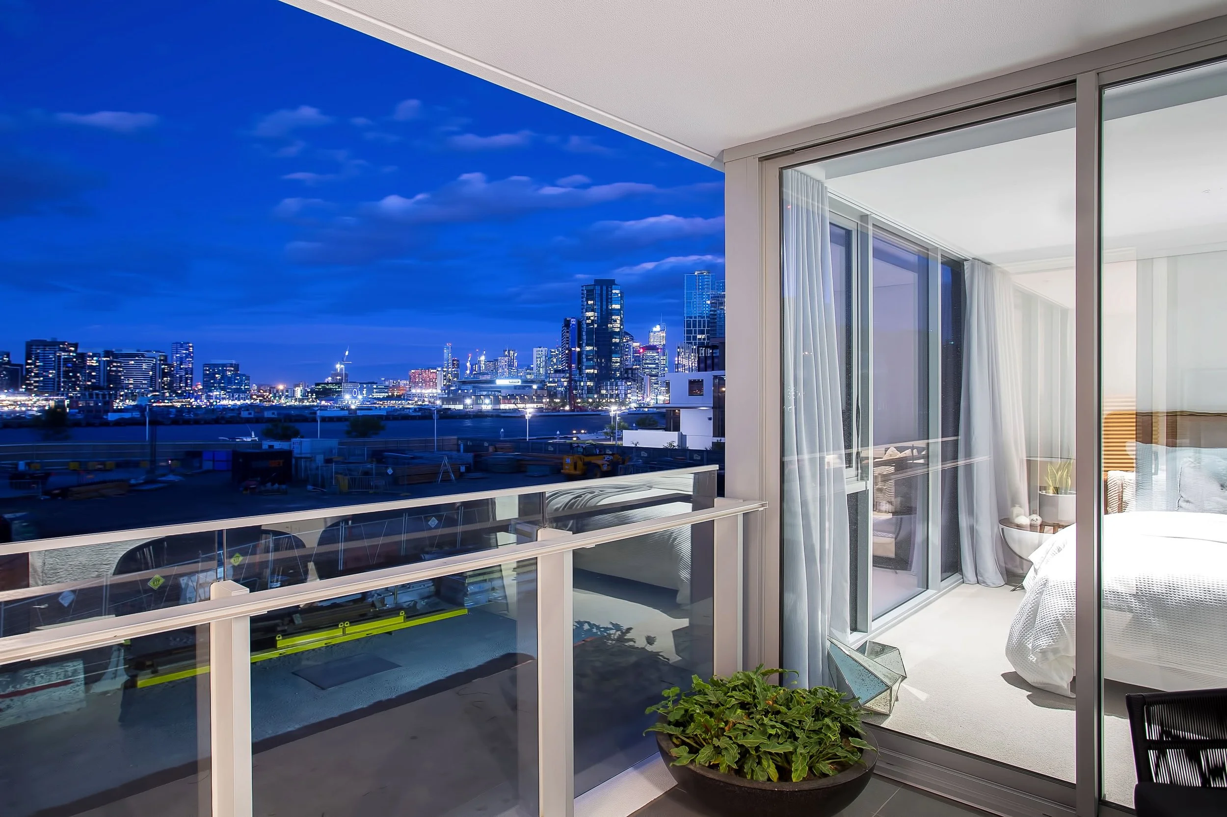 Balcony detail in Forge Docklands Apartment 204 showing glazing, city outlook and outdoor styling elements.