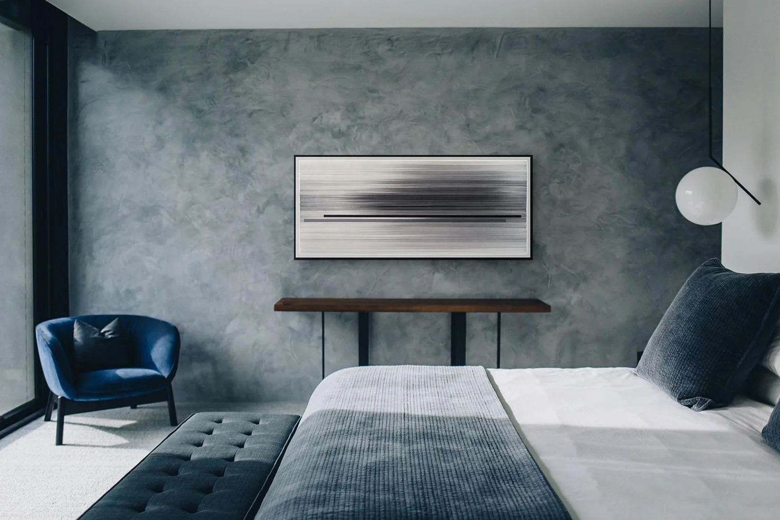 Bedroom with textured grey plaster feature wall and blue accent chair