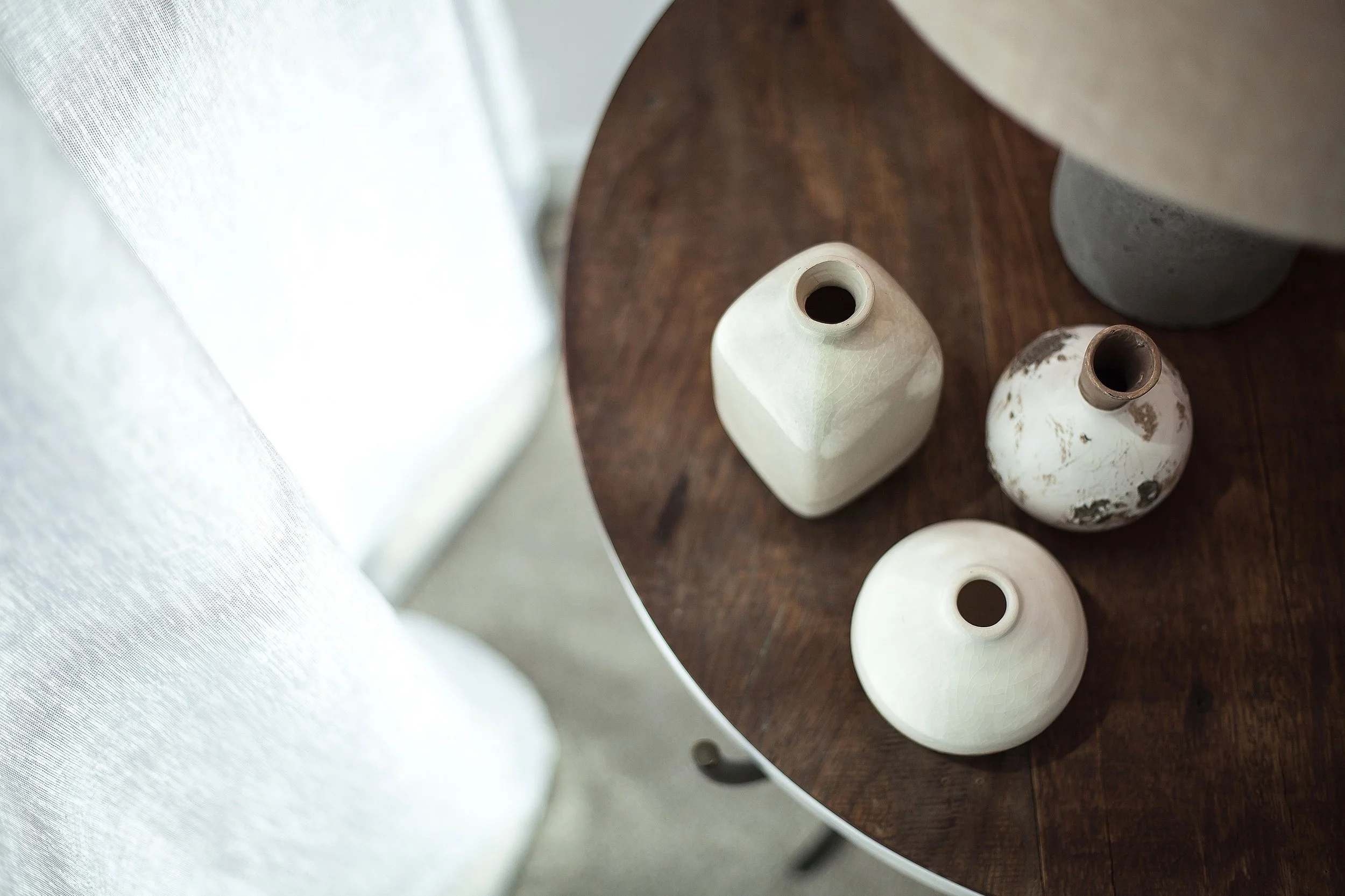 Bedside table styling detail in Forge Docklands Apartment 204 with curated accessories.