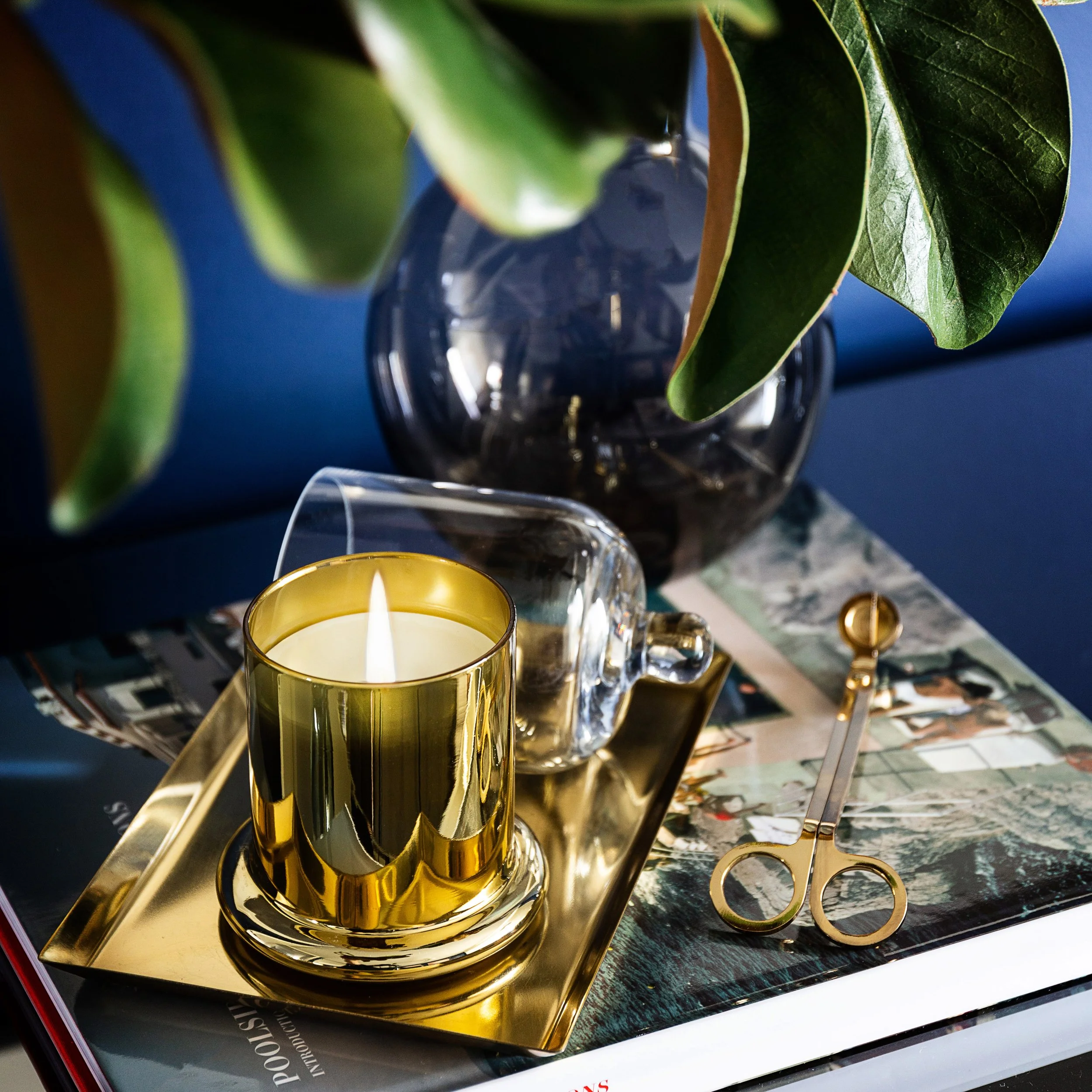 Close up styling detail featuring a brass candle, tray and decorative objects styled for a contemporary Melbourne interior.