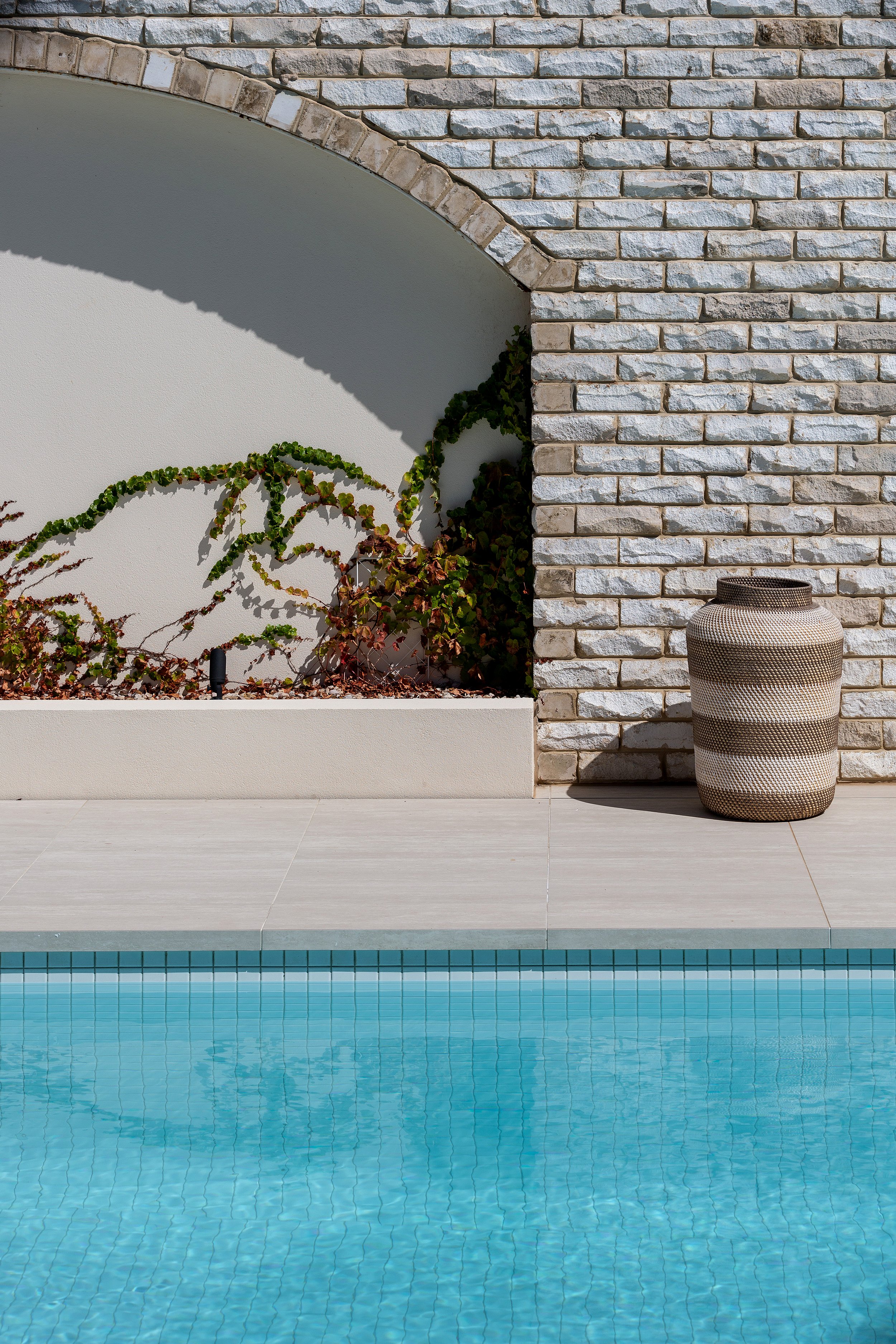 Brick arch and poolside landscape detail at Dromana residence