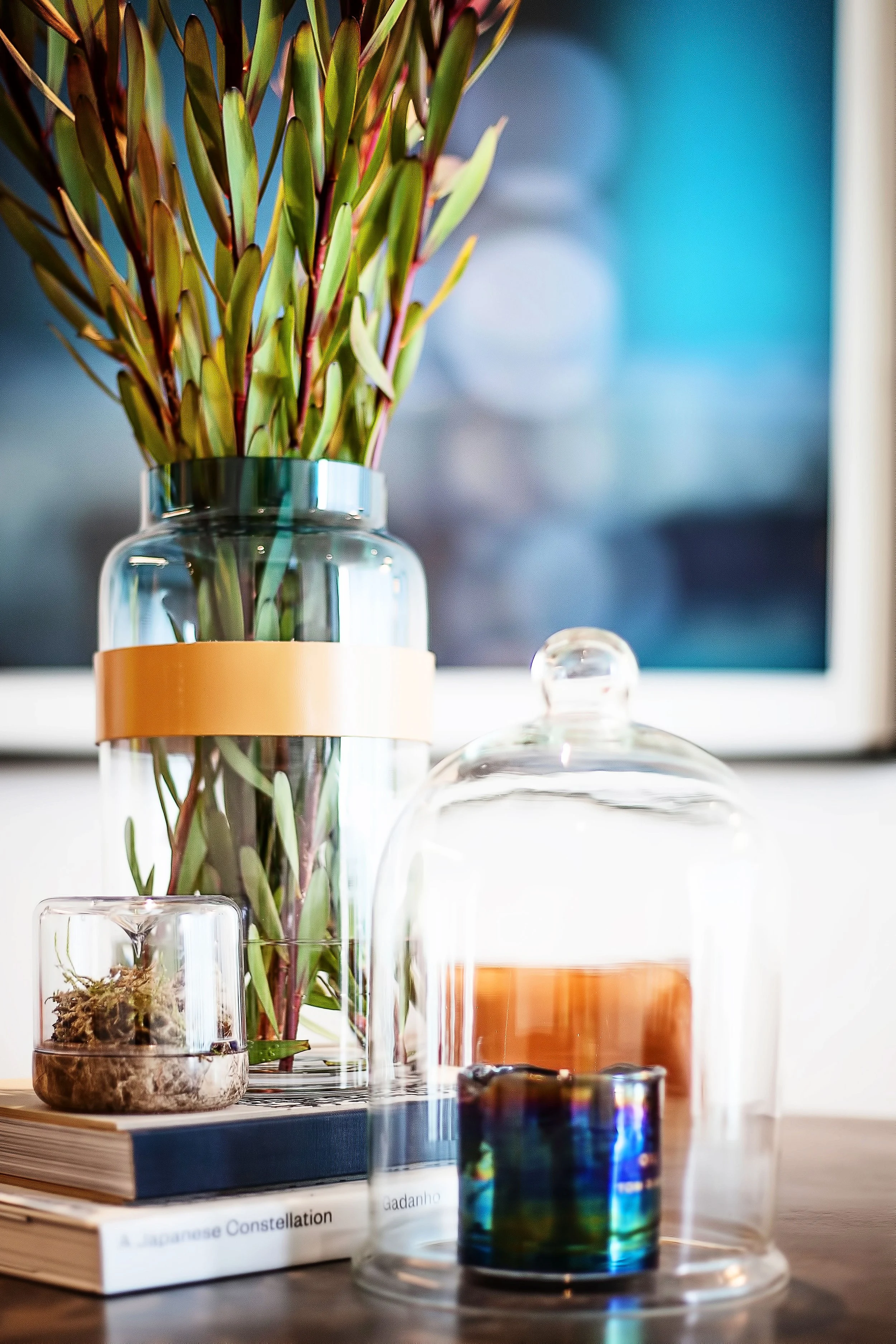 Styled vignette with books, glass dome and floral arrangement in Forge by Mirvac Apartment 204, Docklands Victoria.