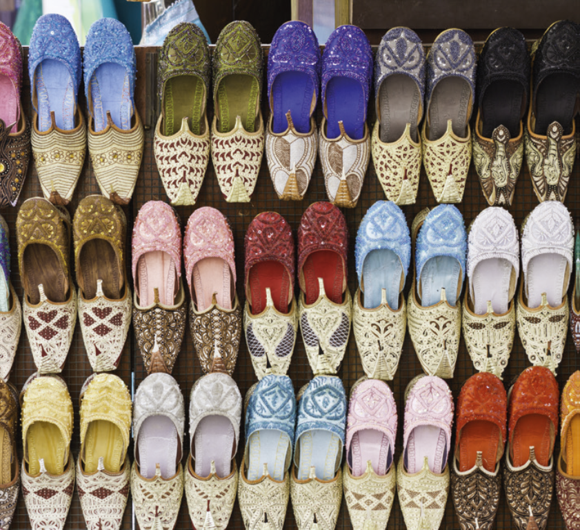 Colorful shoes on display in a traditional souk.