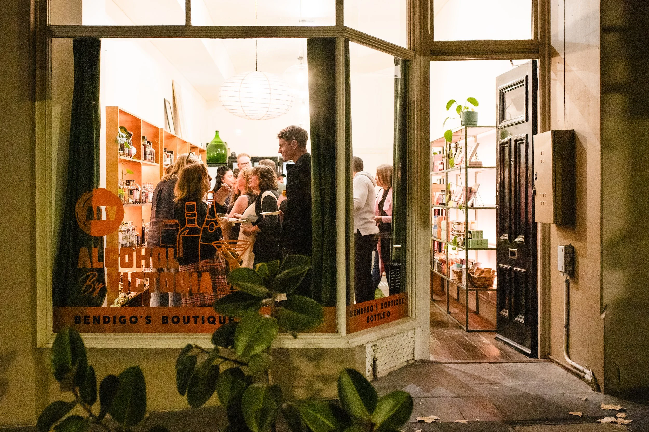 Alcohol By Victora, View Street Bendigo. Front window showing a group of people celebrating opening night.