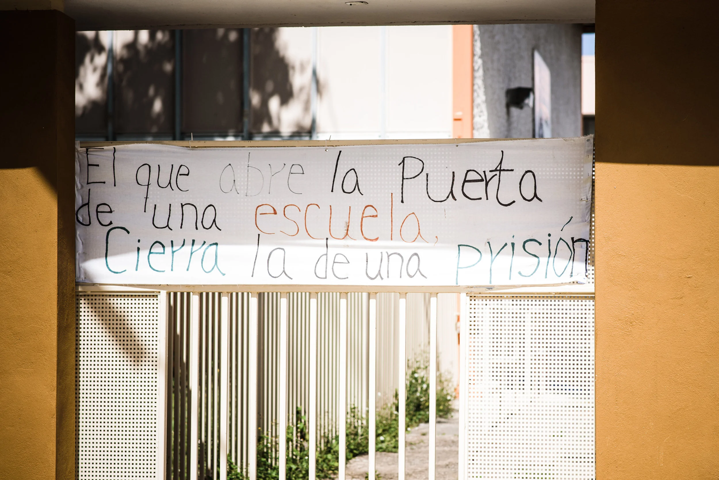 A middle school in the Cantera neighborhood in San Juan, closed since for more than four months at the time the photo was taken. Someone posted a hand lettered sign to the locked gate: “He who opens the door of a school closes a prison.” The displaced students attend classes at another school nearby - a school holding more than double it’s capacity of kids. The host school is an elementary school, so the older kids and younger kids had to share the younger kids’ space. Photo: Aniya Emtage Legaro