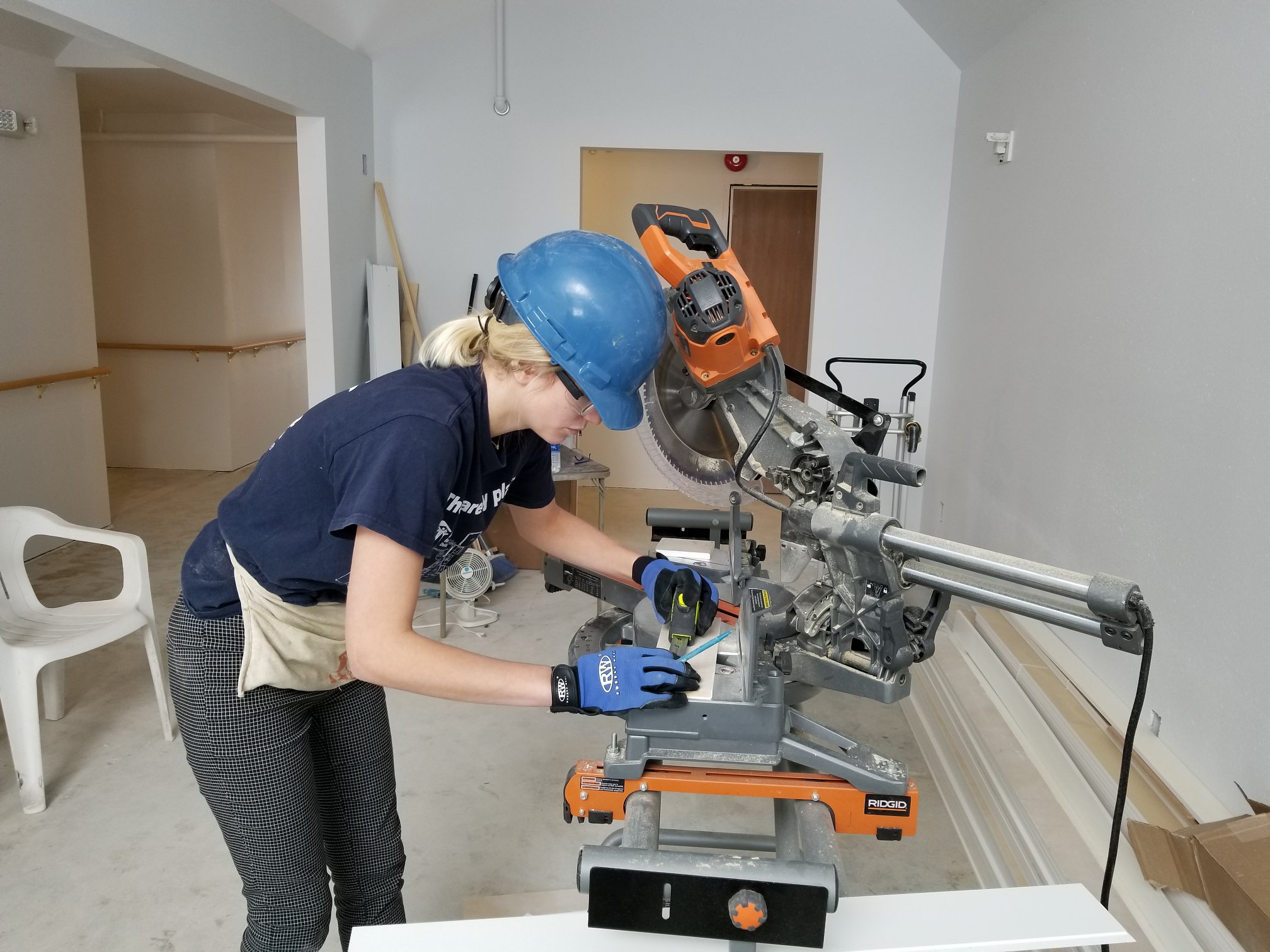 UWM volunteer with miter saw.jpg