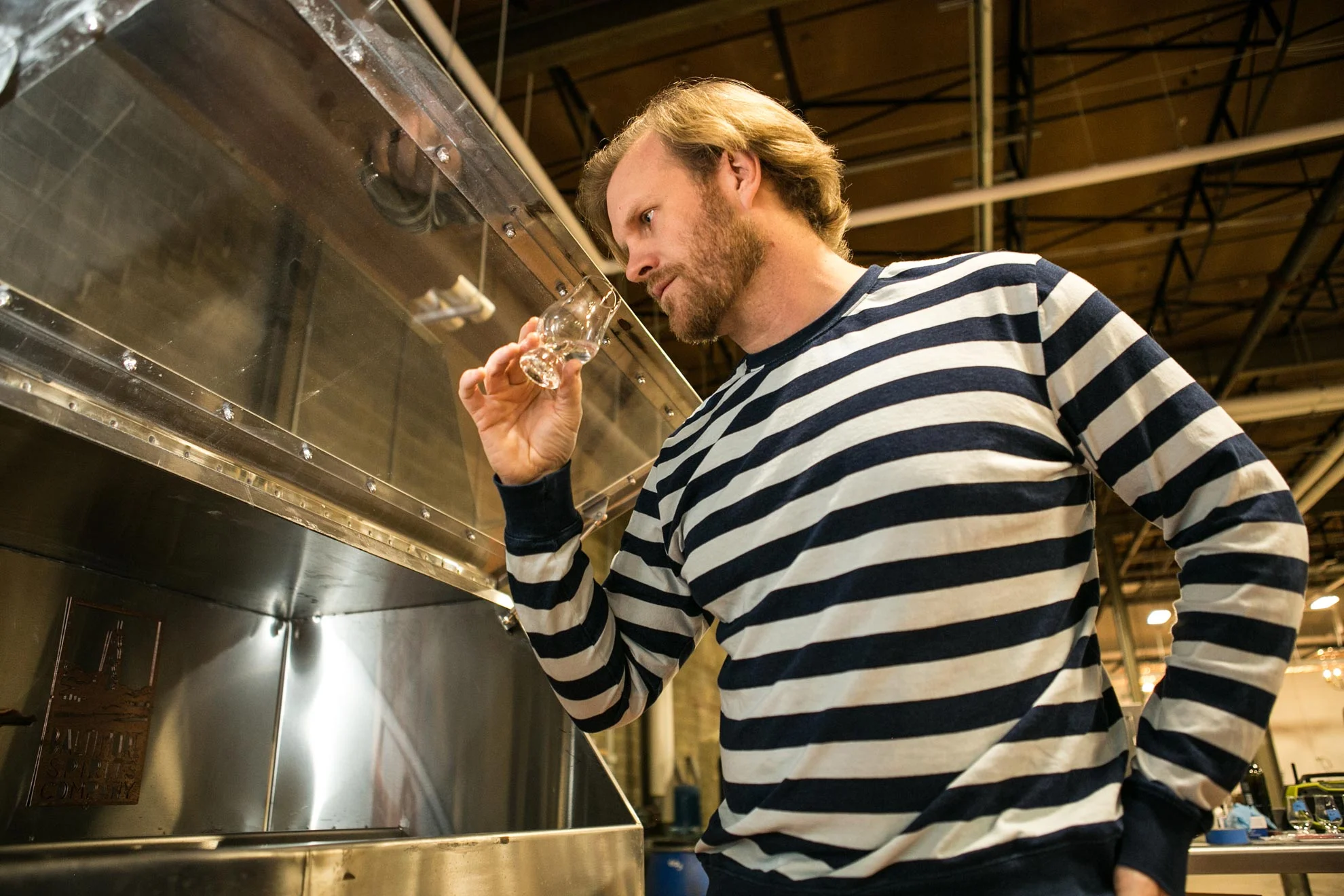 Max Lents of Baltimore Spirits Company quality checks a batch of their craft gin.
