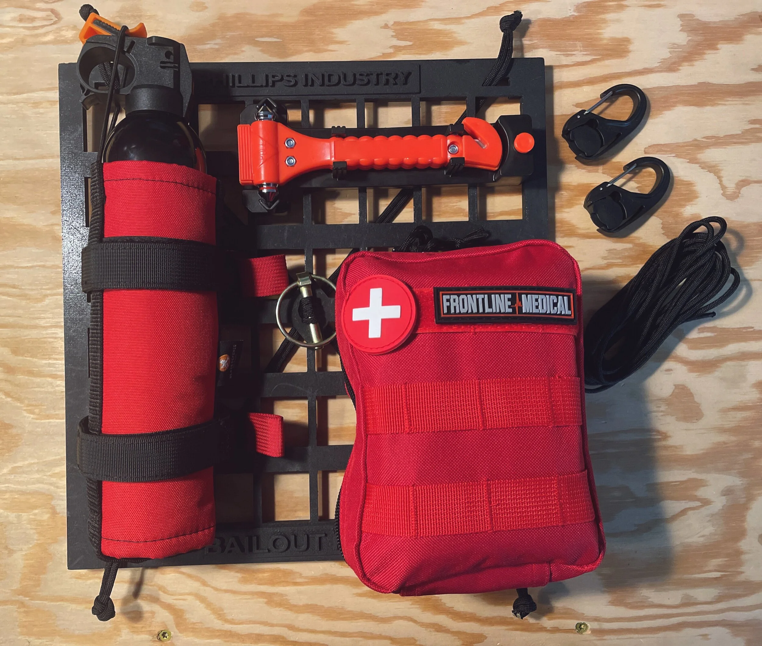 quick release military vehicle seat organizer for fire extinguisher, first aid kit, and glass breaker.