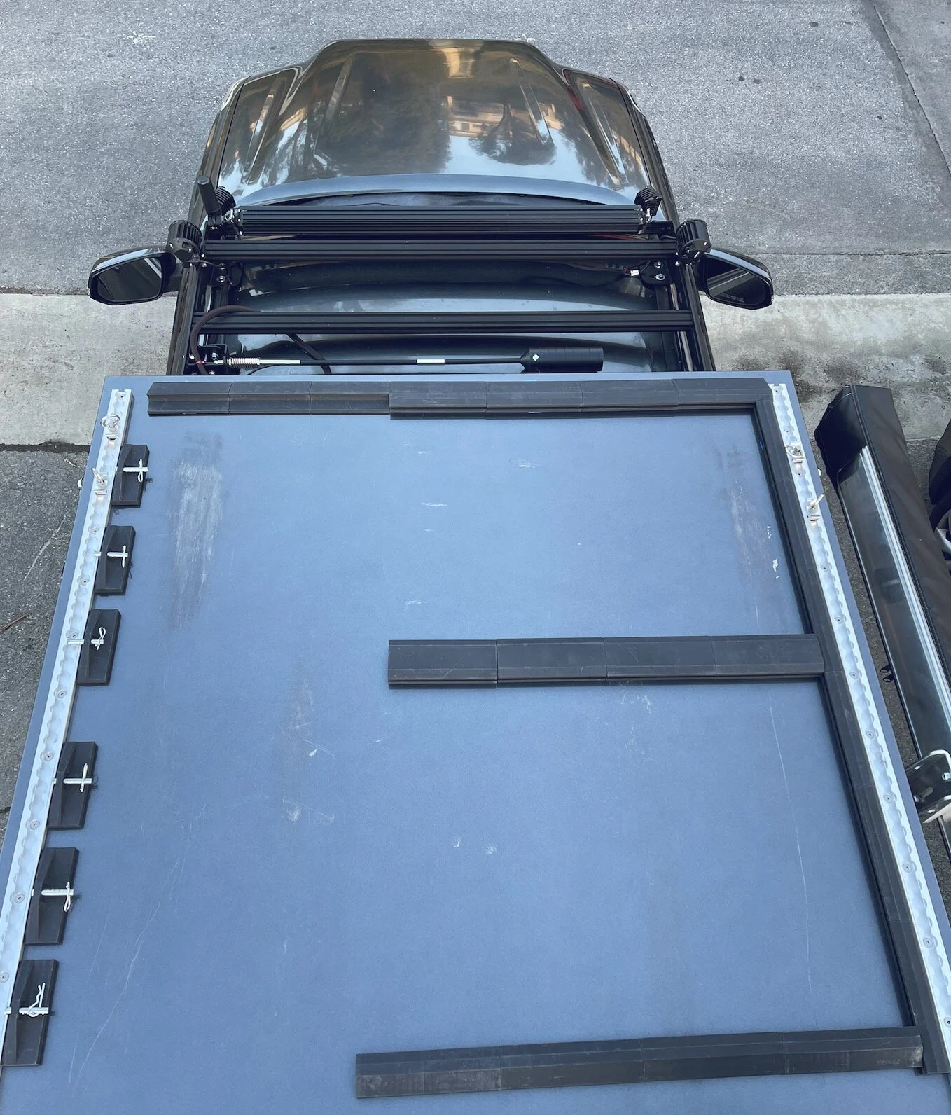 Flexible solar panel mounts on pop up tent on an overland truck