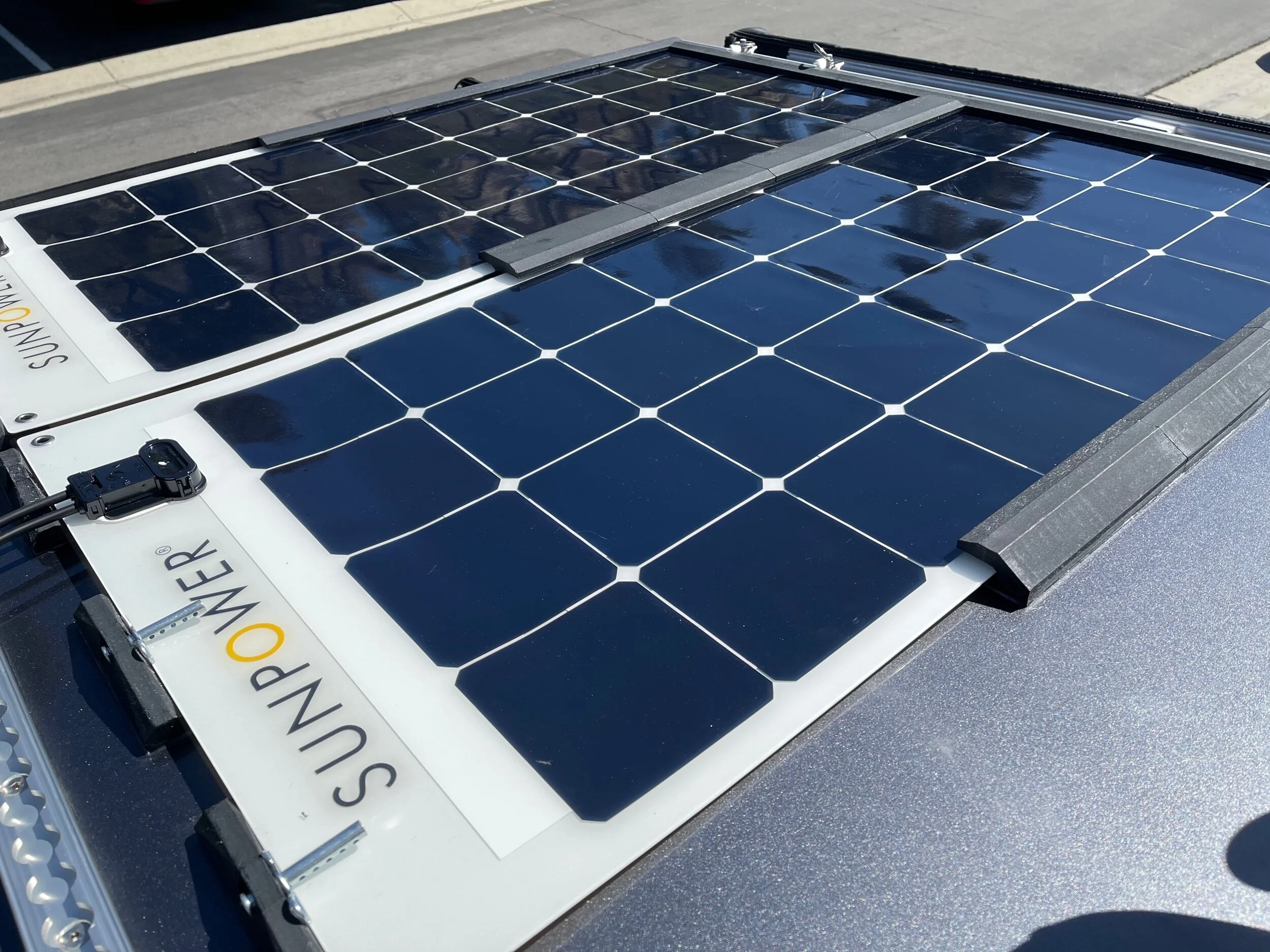 Removeable flexible solar panel mounts for rooftop tents