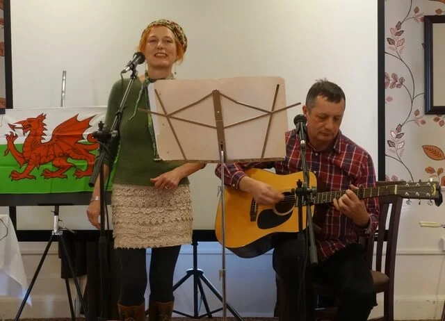 Andrea and Straford Wild playfully perform together as BOTH WILD.