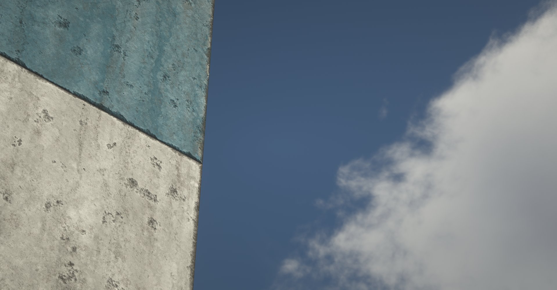 Close-up of a building corner with textured blue and white concrete walls, against a partly cloudy blue sky.