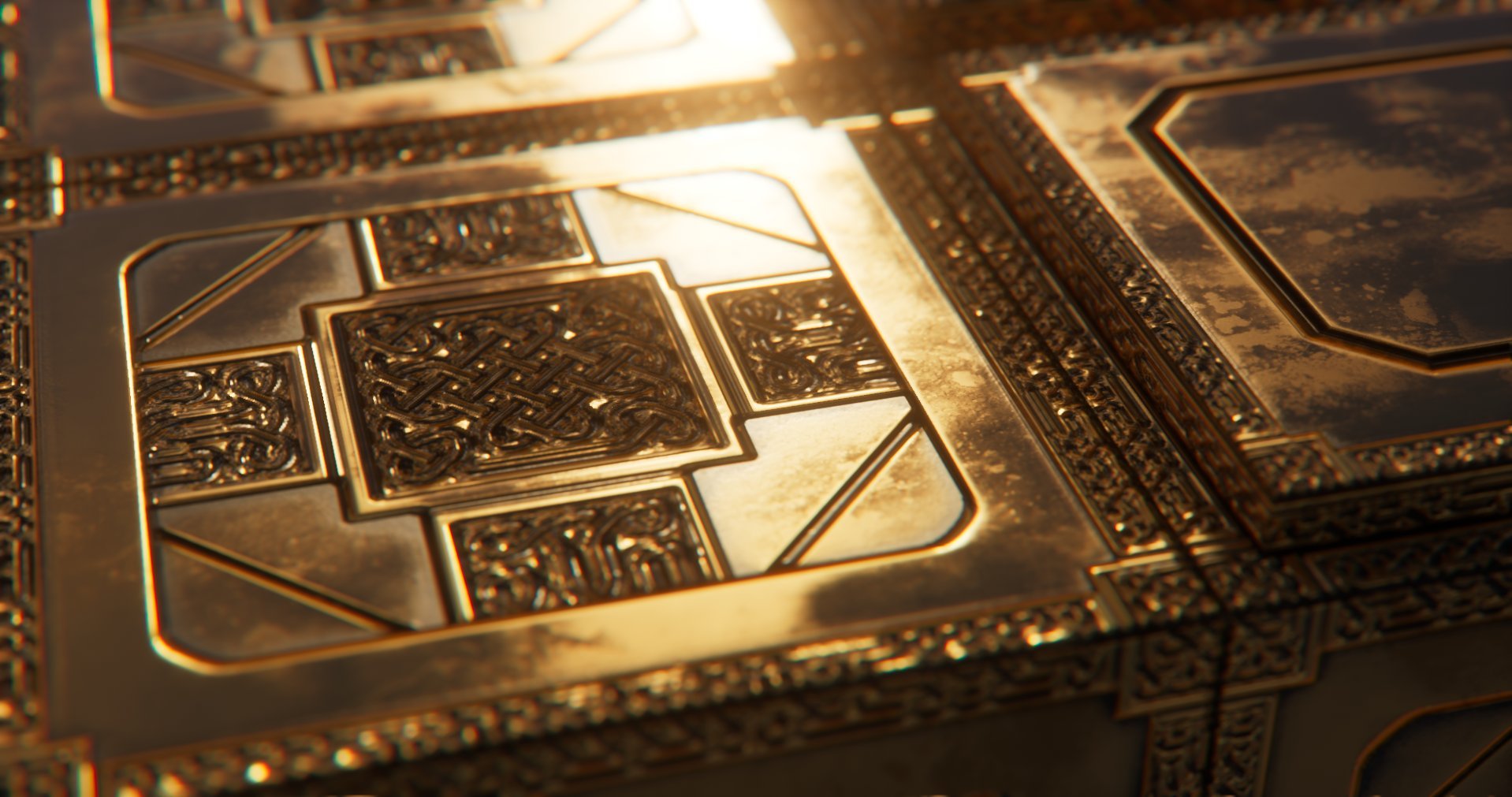 Close-up view of a gold-colored metallic sculpture with intricate geometric and abstract patterns.