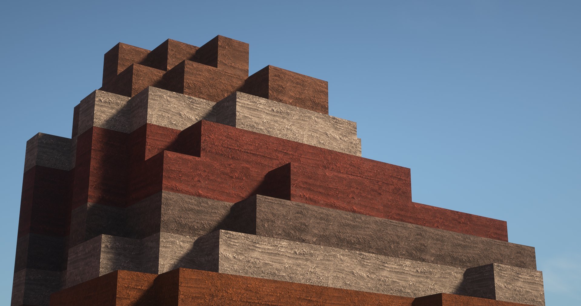 Close-up of a stepped, pyramid-like structure made of layered red, brown, and gray stone blocks with a clear blue sky in the background.
