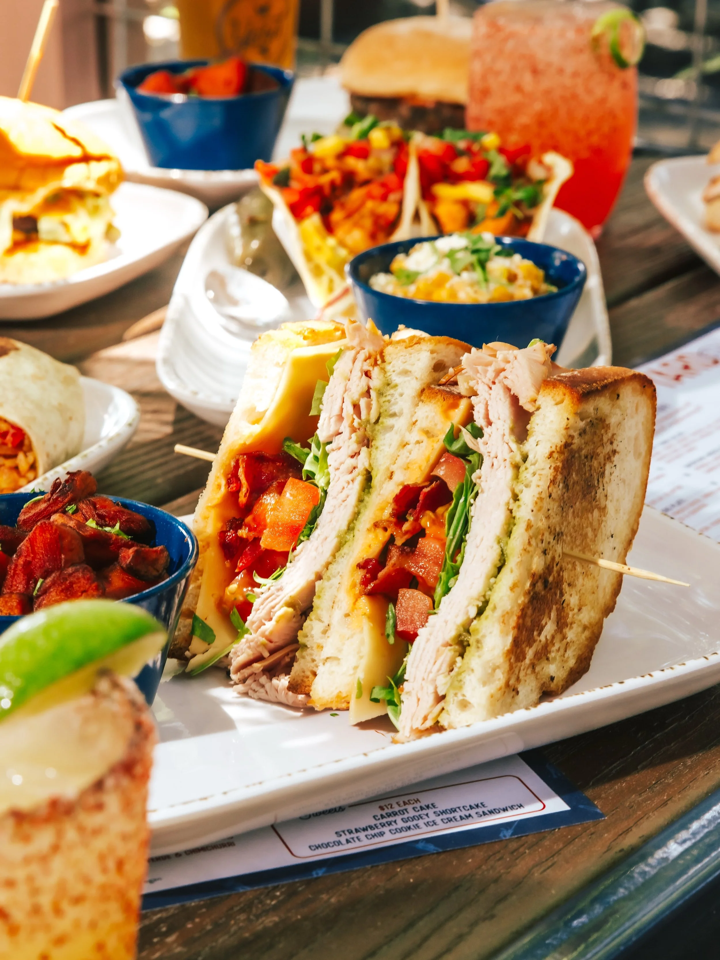 The Church Street Club. Layer after layer of smoked turkey, avocado, crispy bacon, havarti, and cholula mayo on griddled sourdough. Fair warning: once you pick it up, you&rsquo;re committed. 🔥