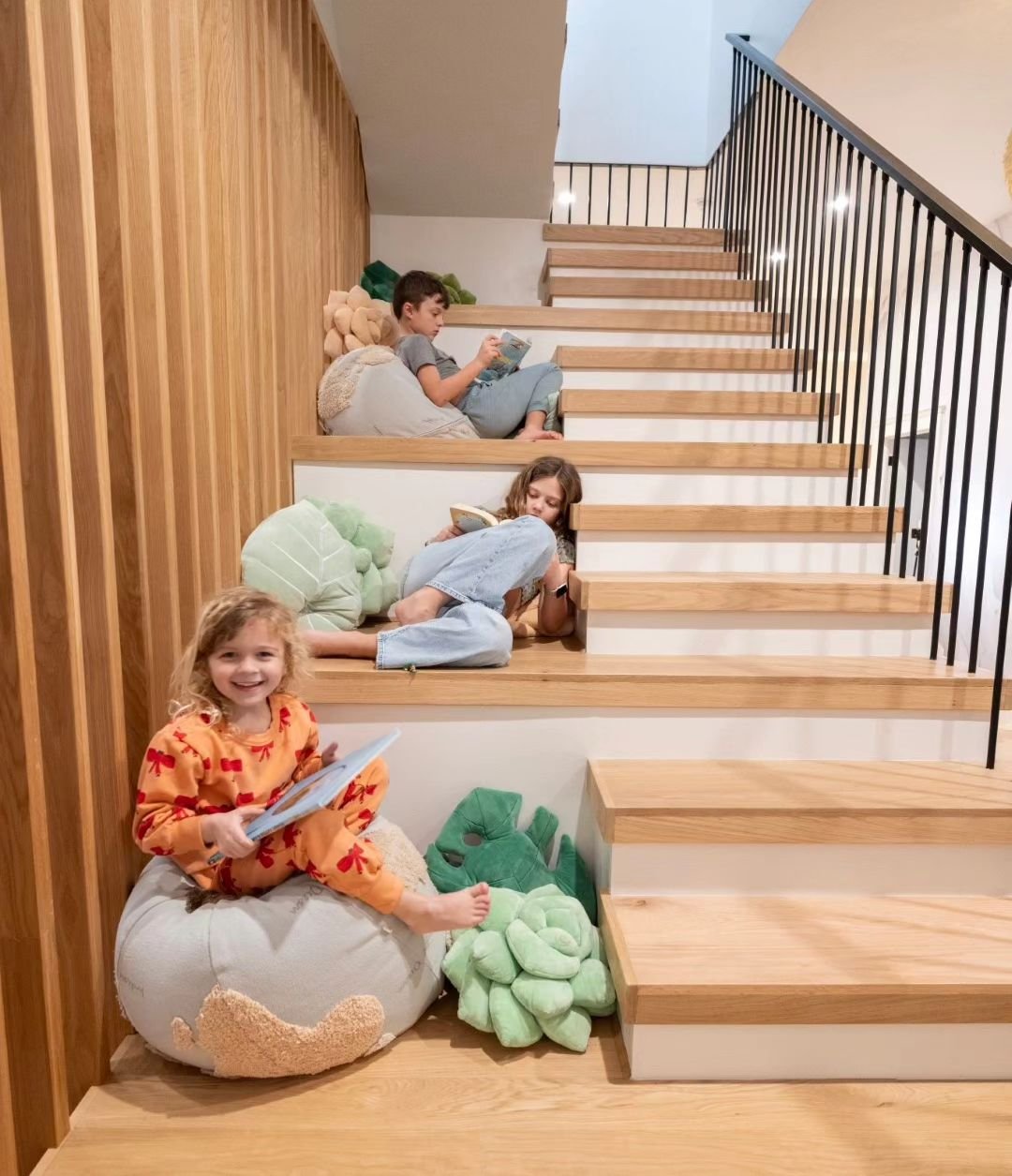 This stair, designed by Buckminster Green for a recent whole house remodel, has bleacher seating every third step for hanging out. The treads and slat wall are white oak.