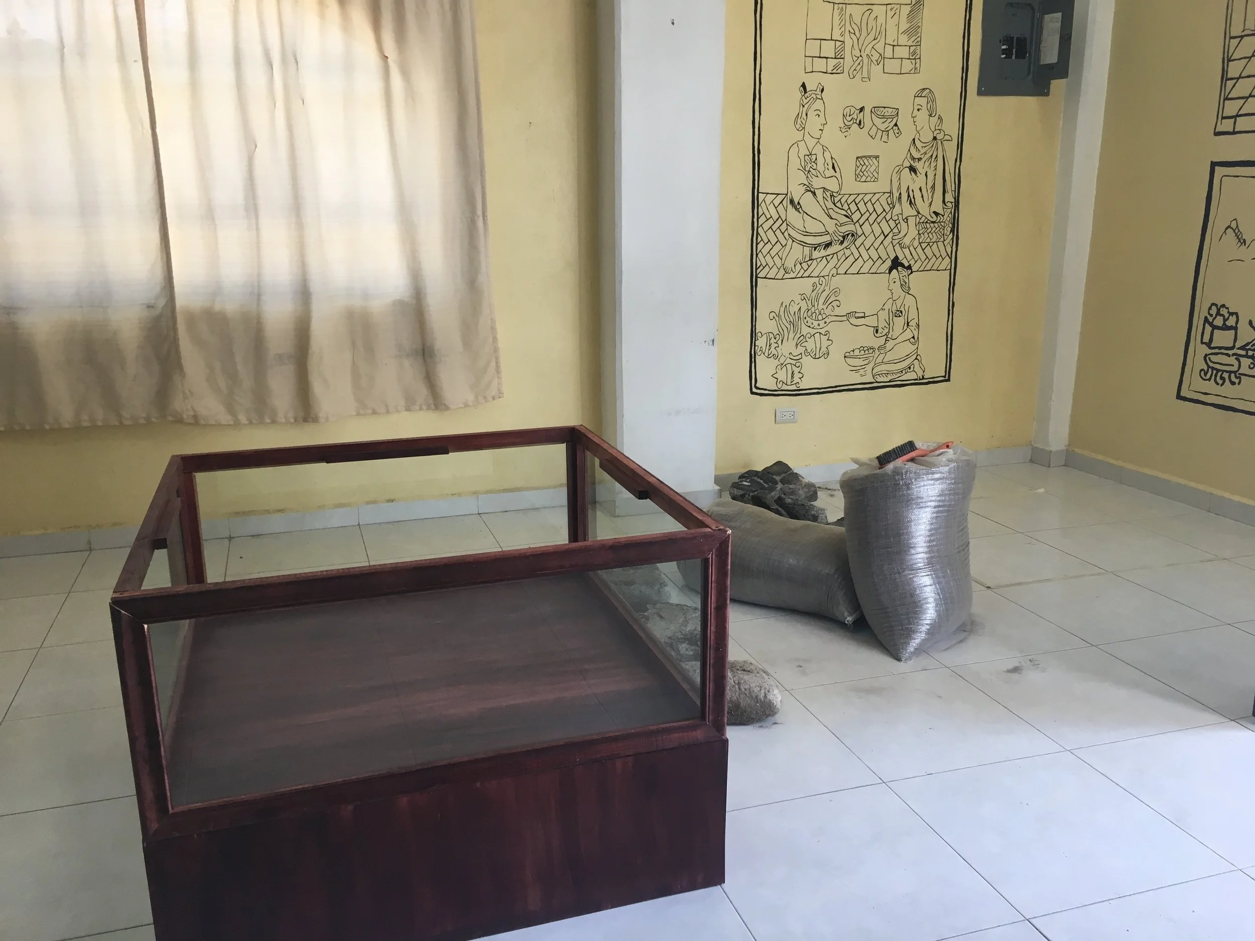 The first vitrine is in position! We ultimately decided to install the vitrines first, and then to construct the replica features (a hearth and an altar) into the vitrines once they were positioned in the museum.