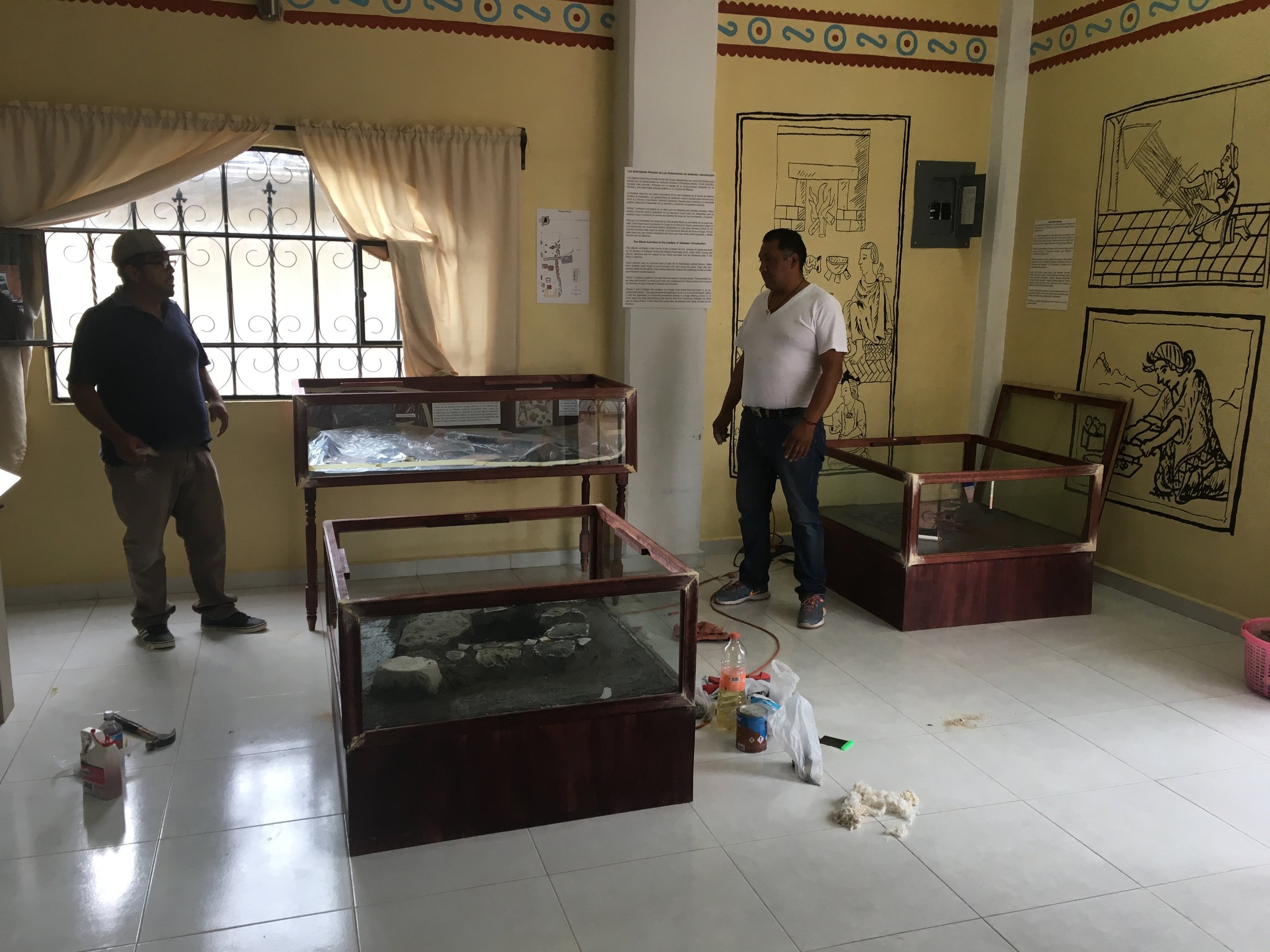 Isidro and Joel make final touches to the vitrines and displays the day before the opening ceremony for the exhibit.