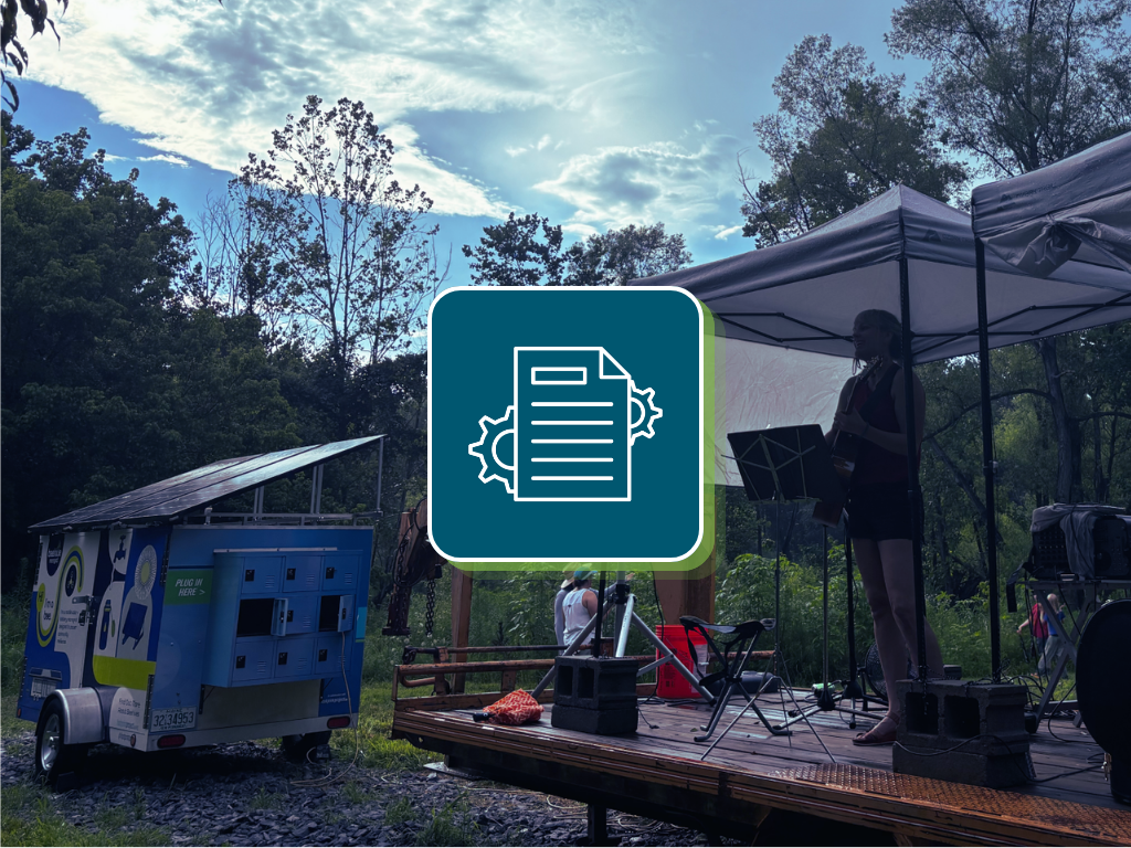 Photo of an event being powered by a Beehive Microgrid. On the center of the photo is an icon of a program with gears.