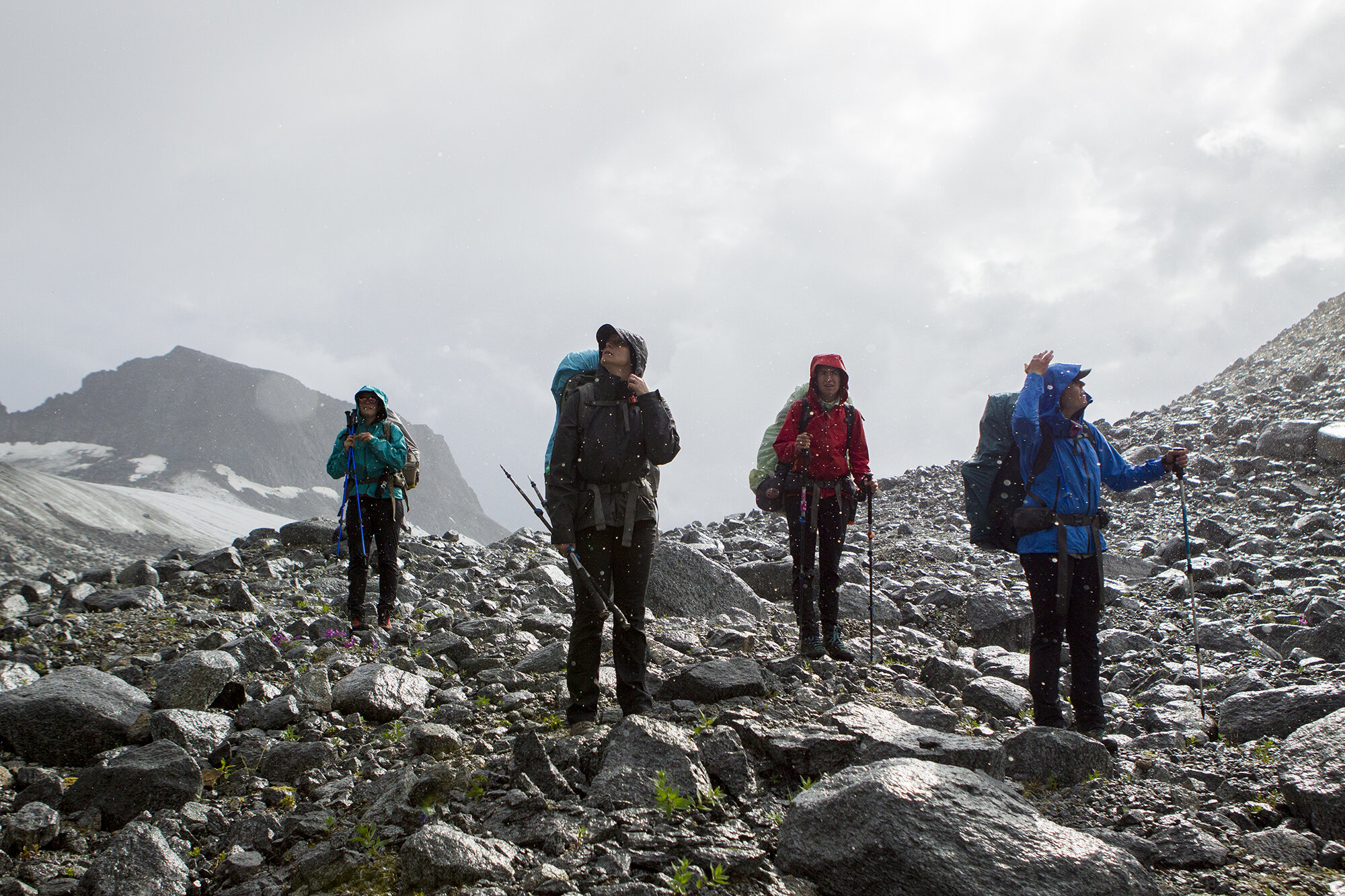 women backpacking over glacier