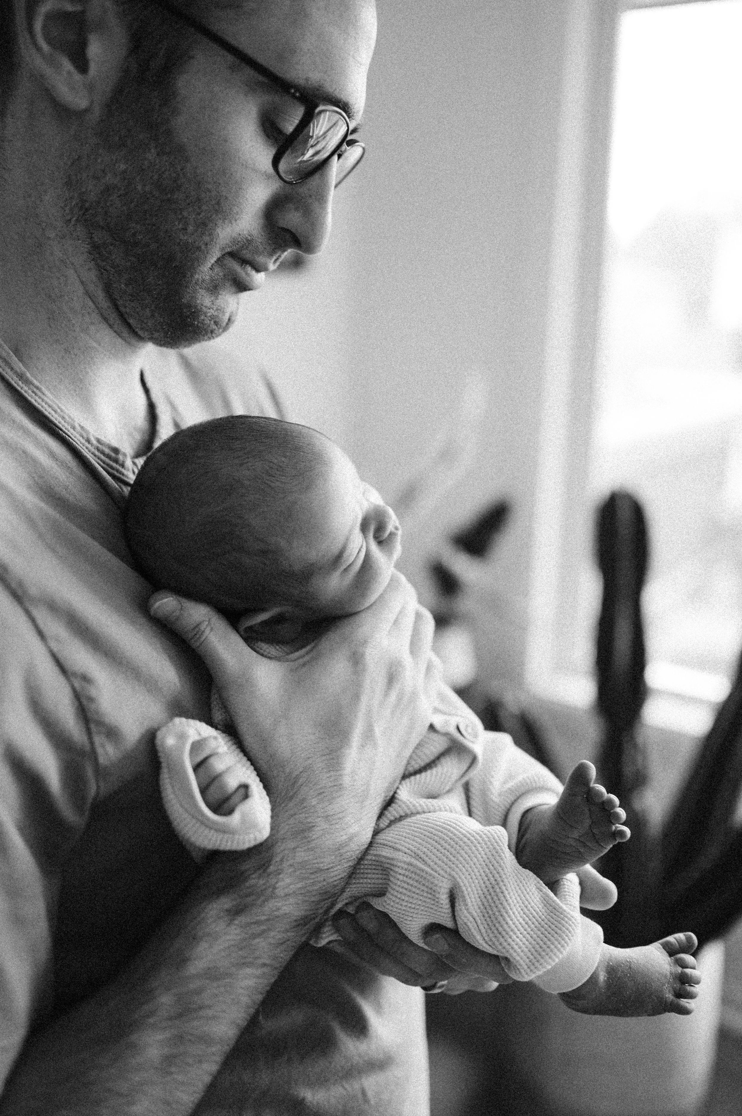 Dad holding newborn baby