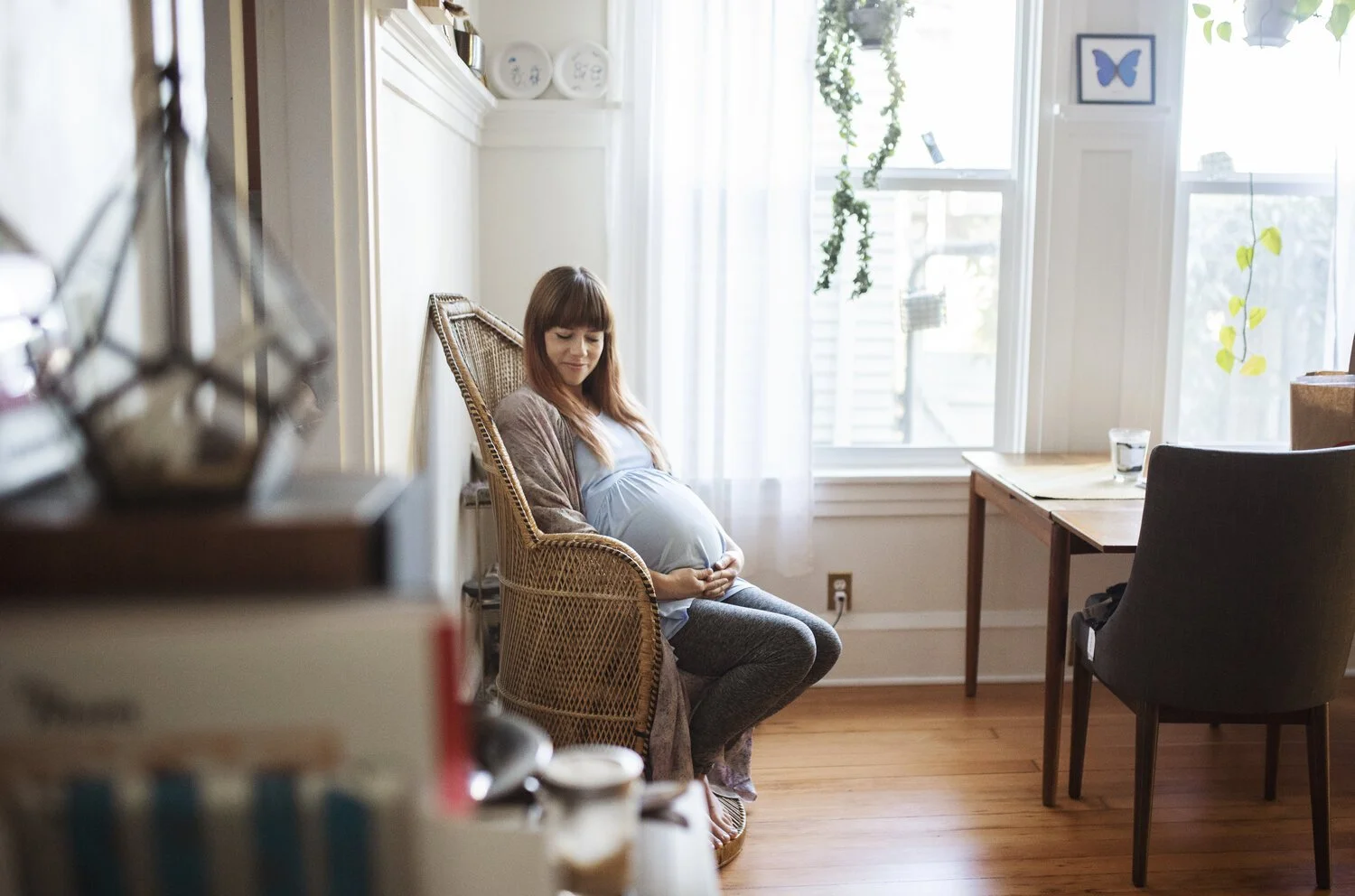mom to be sitting in chair in living room