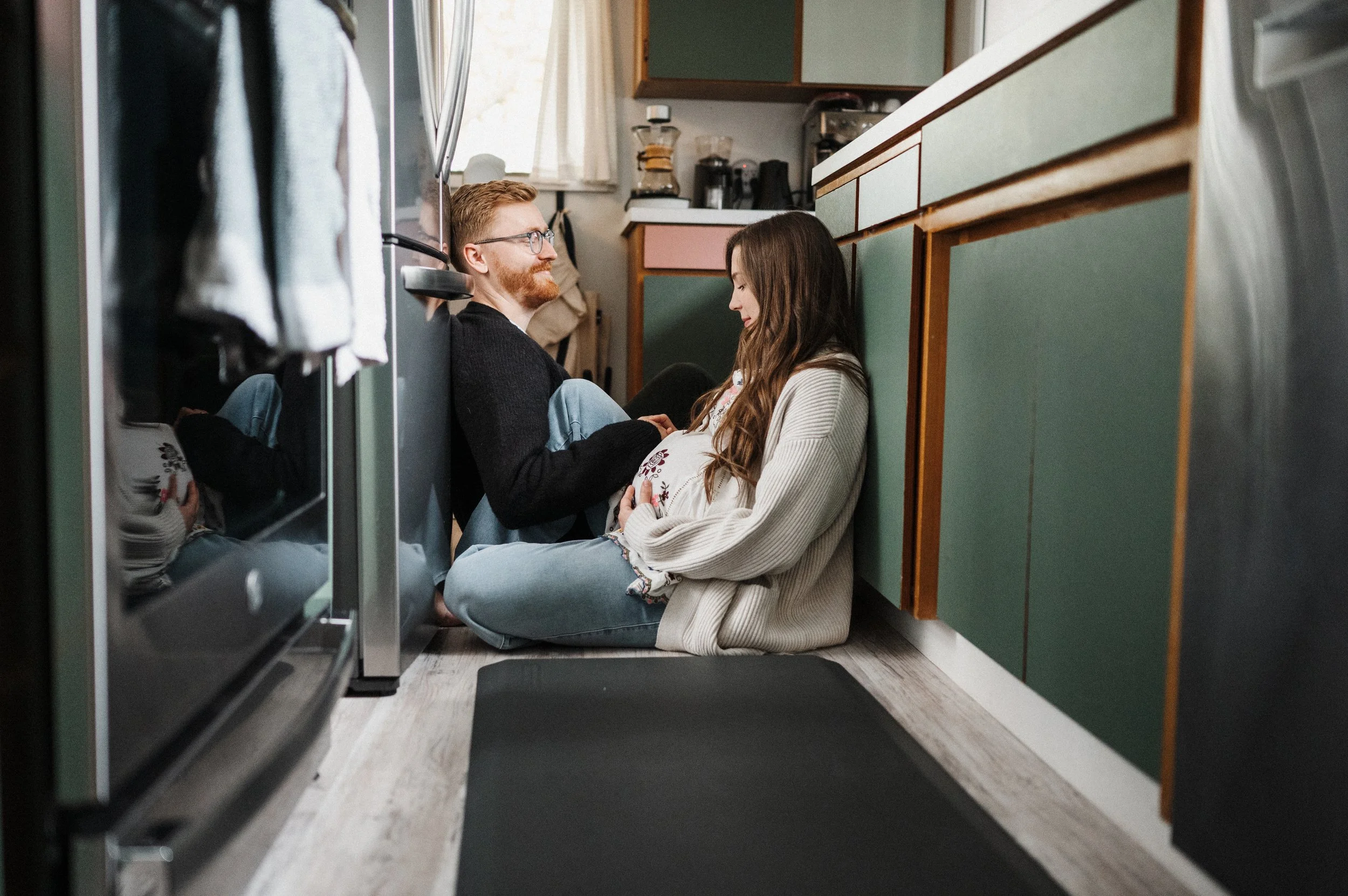 mom and dad to be sitting in kitchen