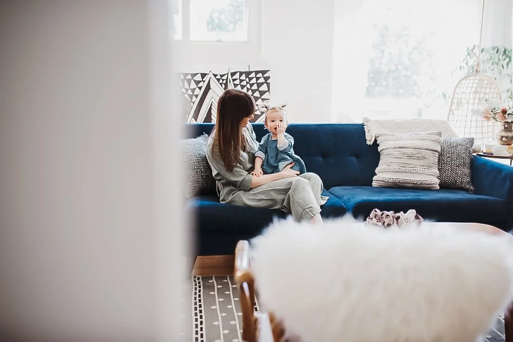 mom and baby on couch in living room