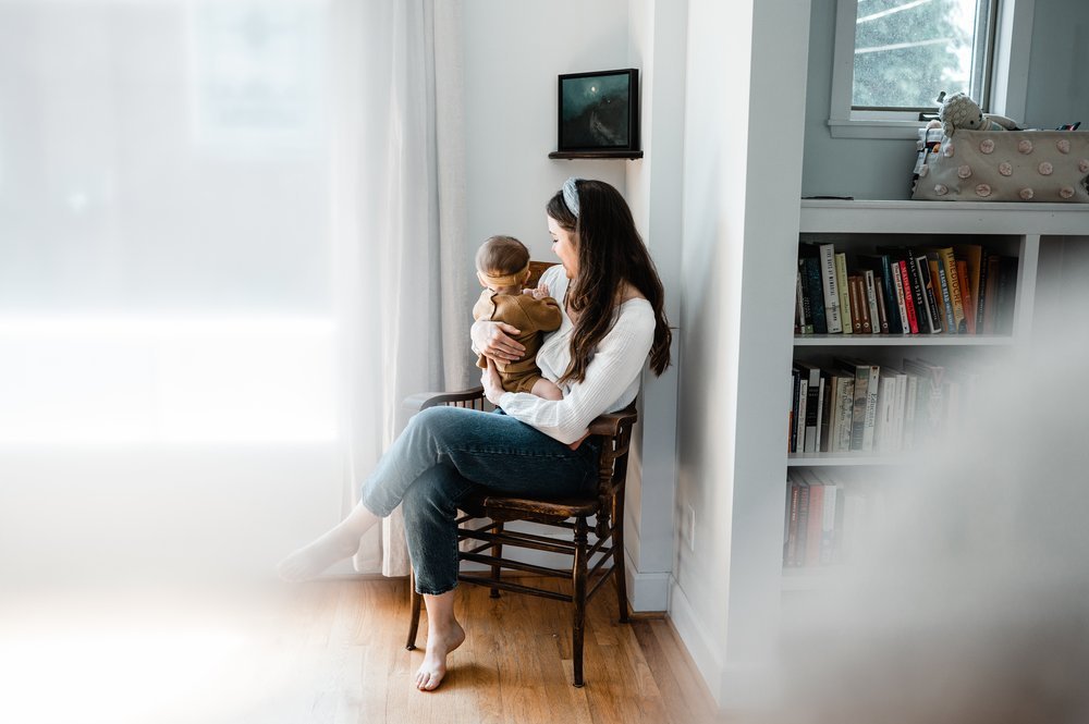 mom snuggling with baby in living room