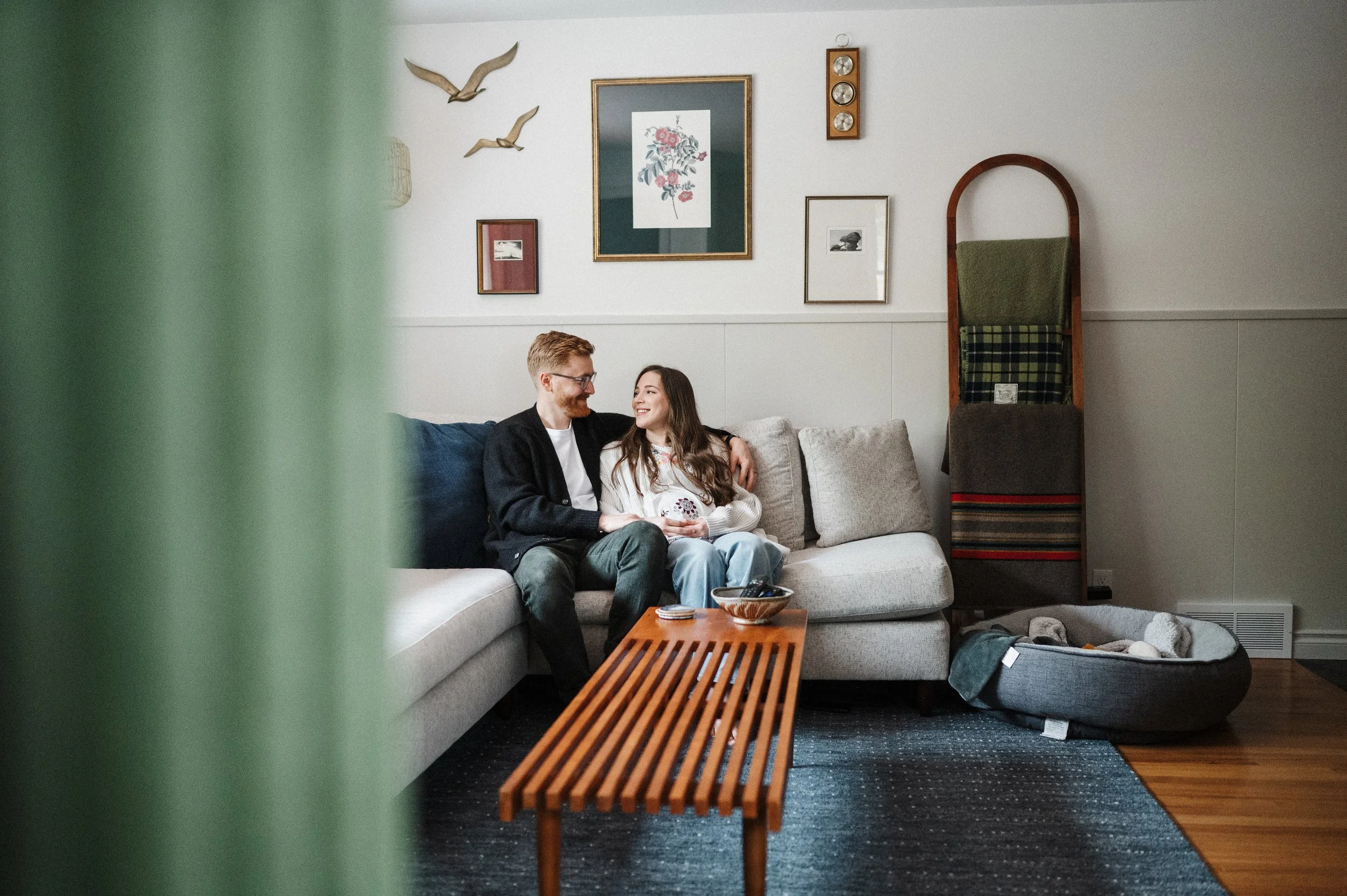 Mom and dad to be sitting on couch