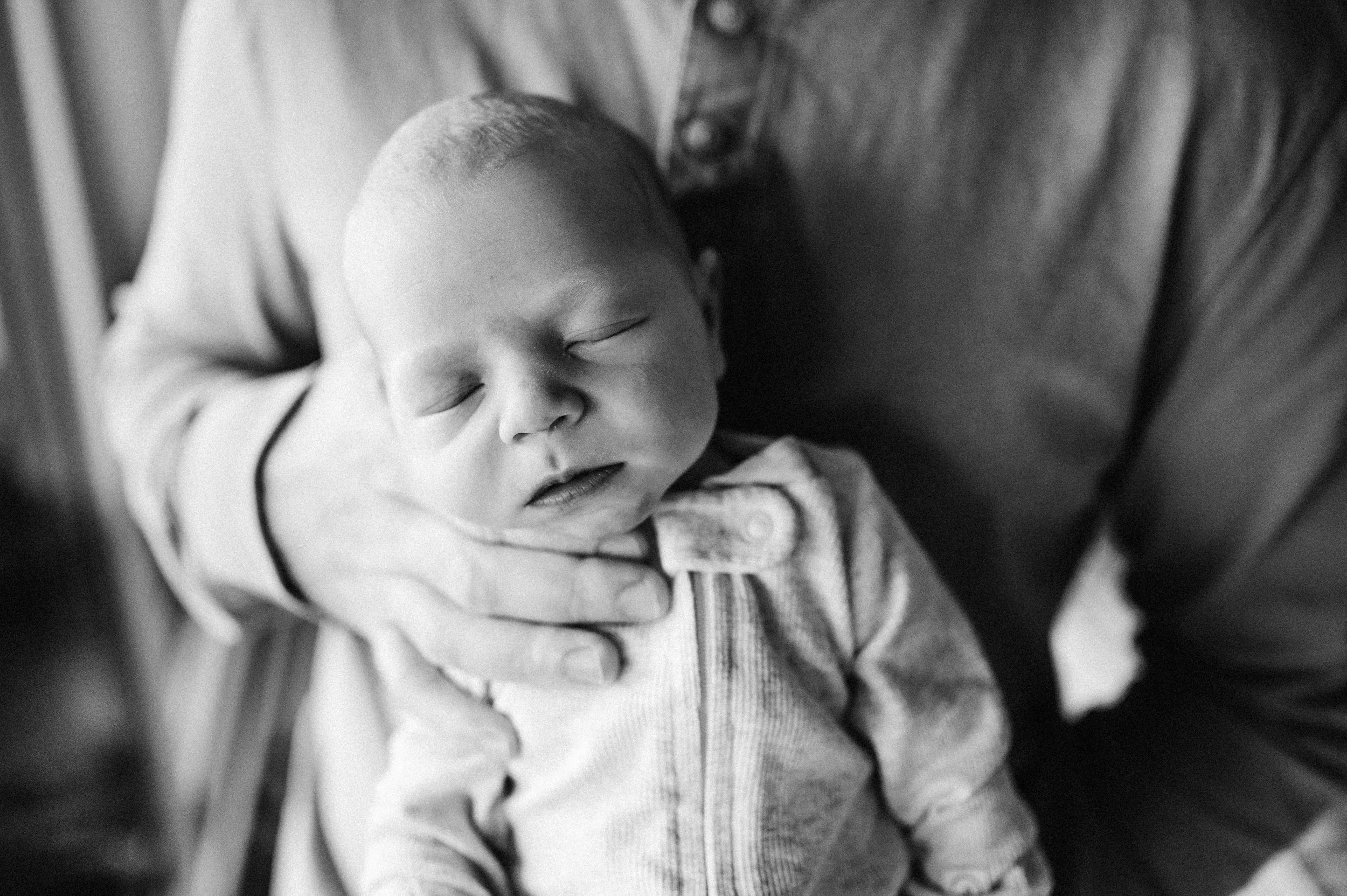 Sleeping baby in dad's arms
