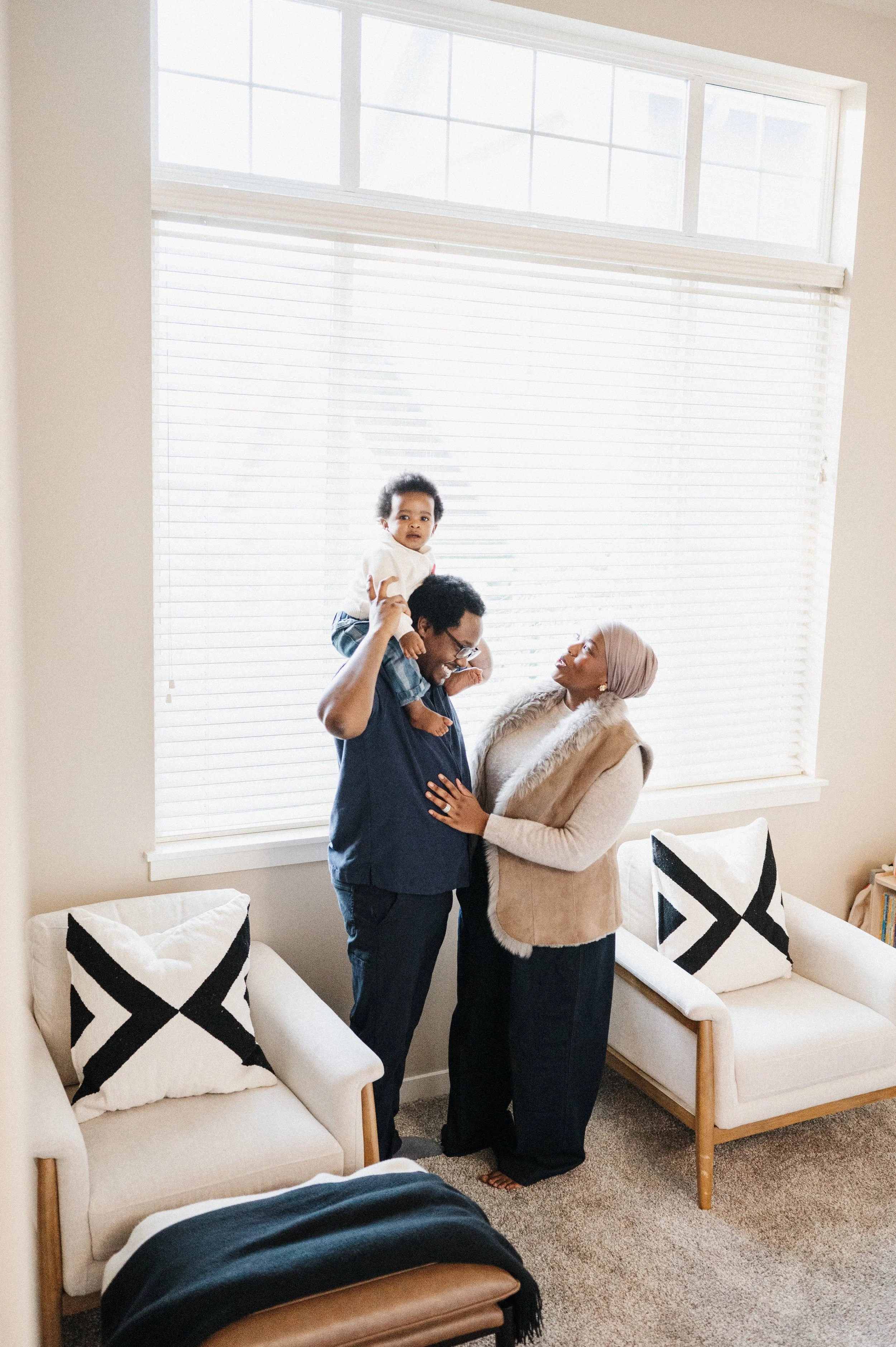 family of three standing in Seattle living room