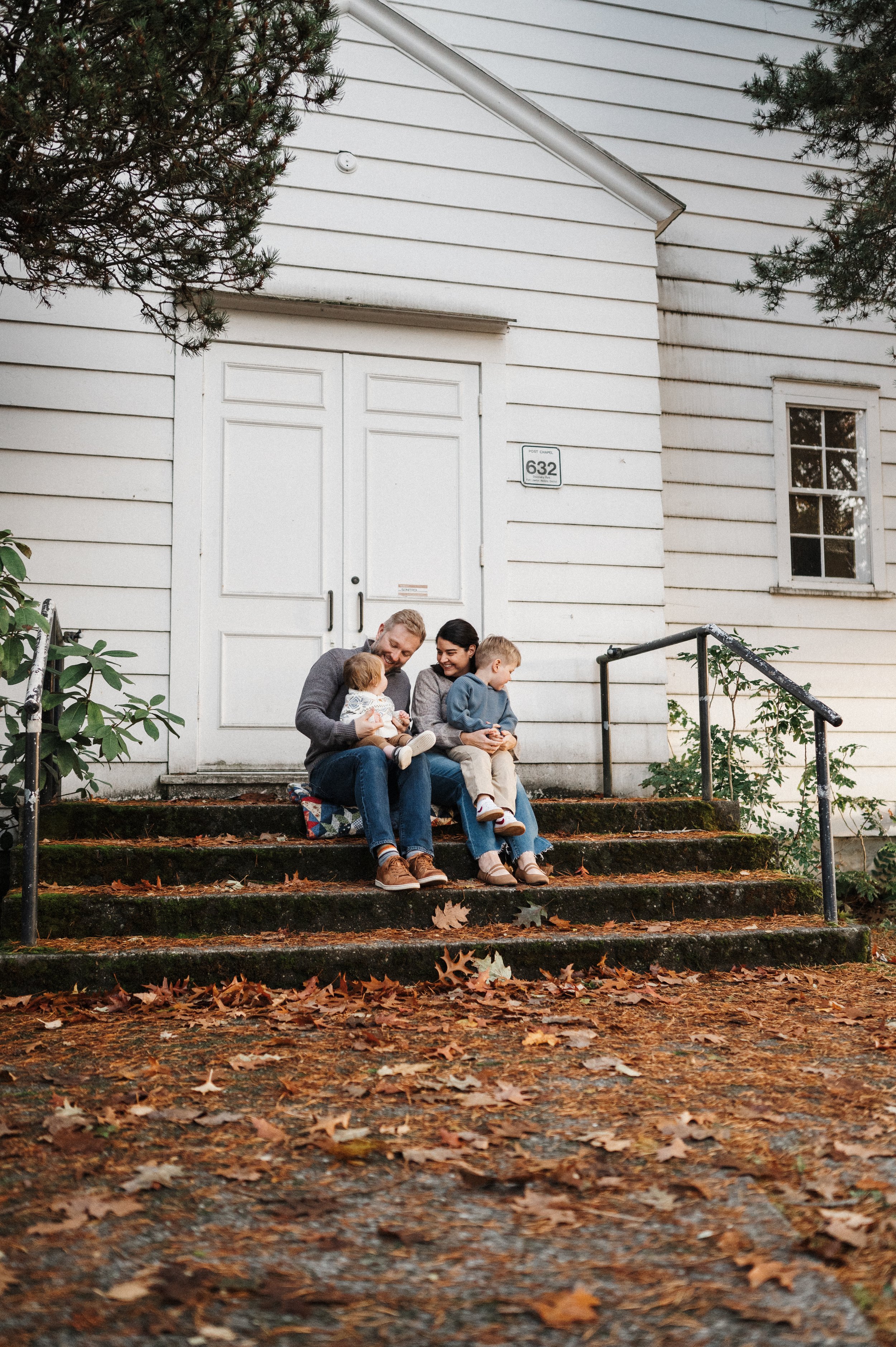 family of four sitting together during photo session