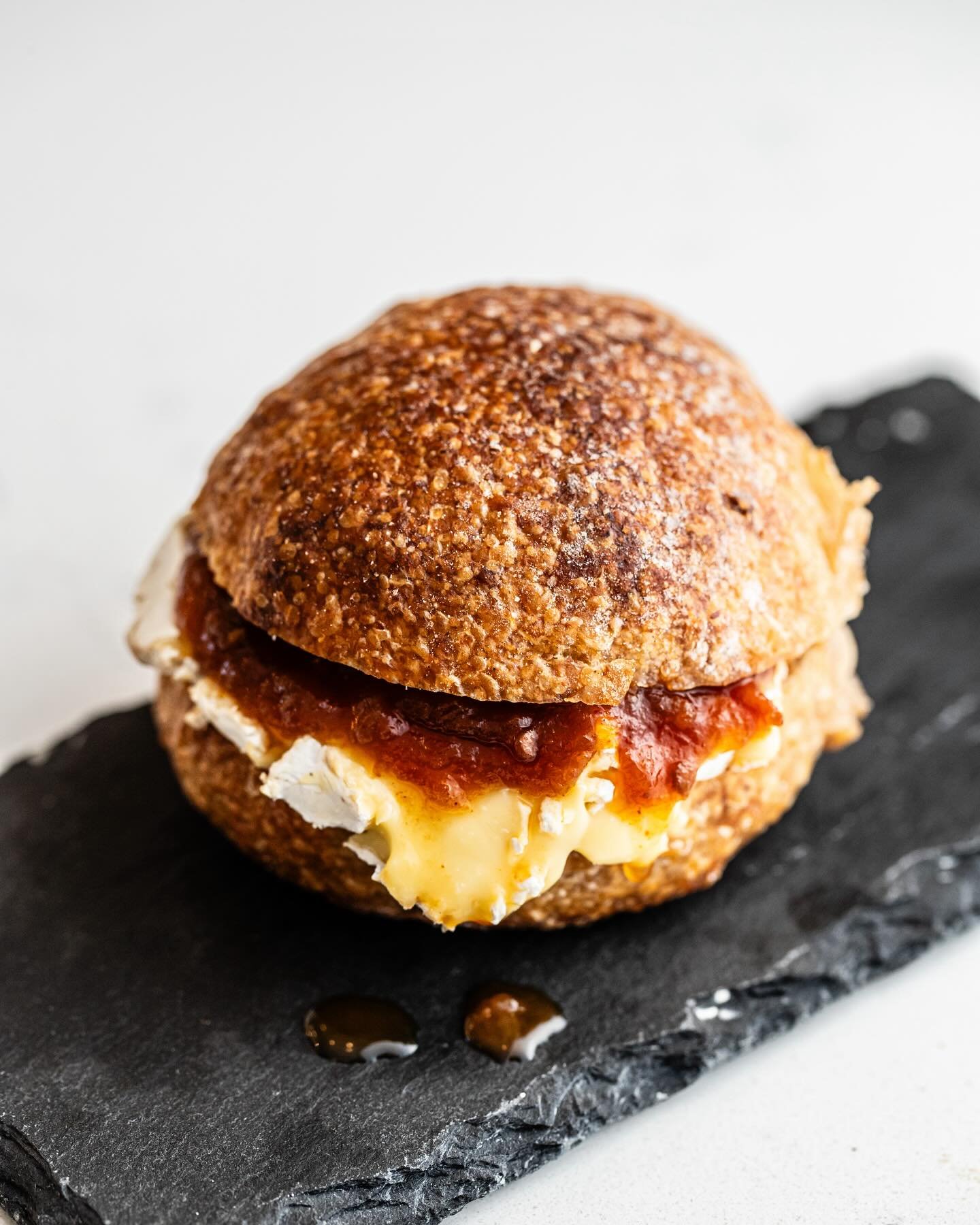 Have you met our &ldquo;3 biter&rdquo; sandwich? 

You can choose a cheese out of our extensive range, add a relish &amp; the cold-cut of the day (if you like).
🥖 + 🧀 ++ = 😋 

The one pictured features Extravagant triple cream &amp; chilli tomato 