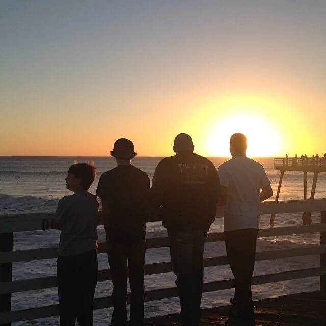 John with his family: Blake, Tanner, and Zach.