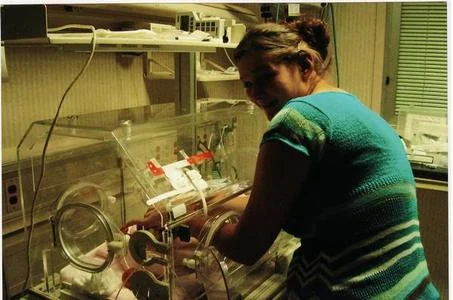 Kyle spending time with her daughter in the NICU.