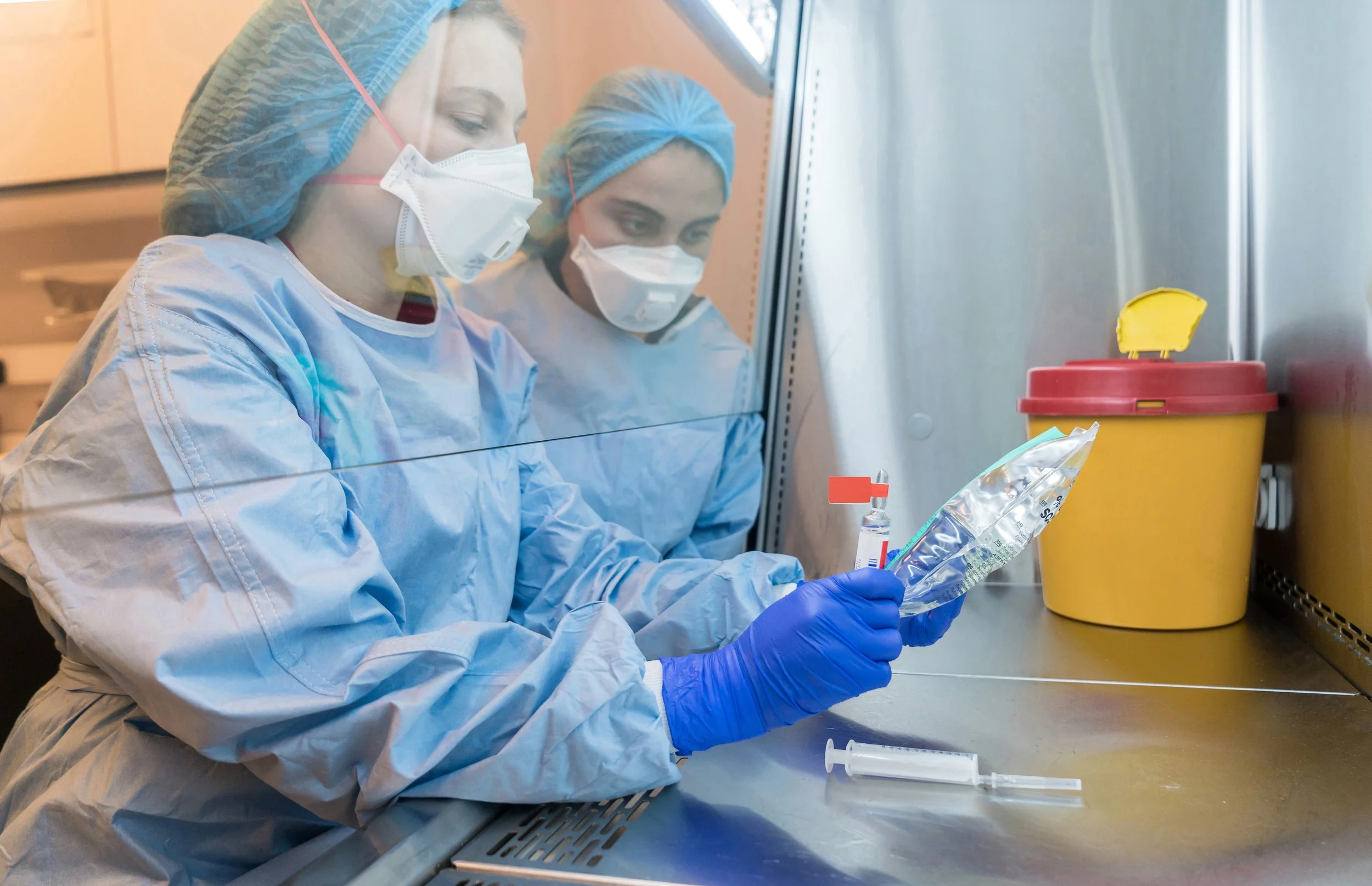 Two pharmacists prepare medicines for treatment