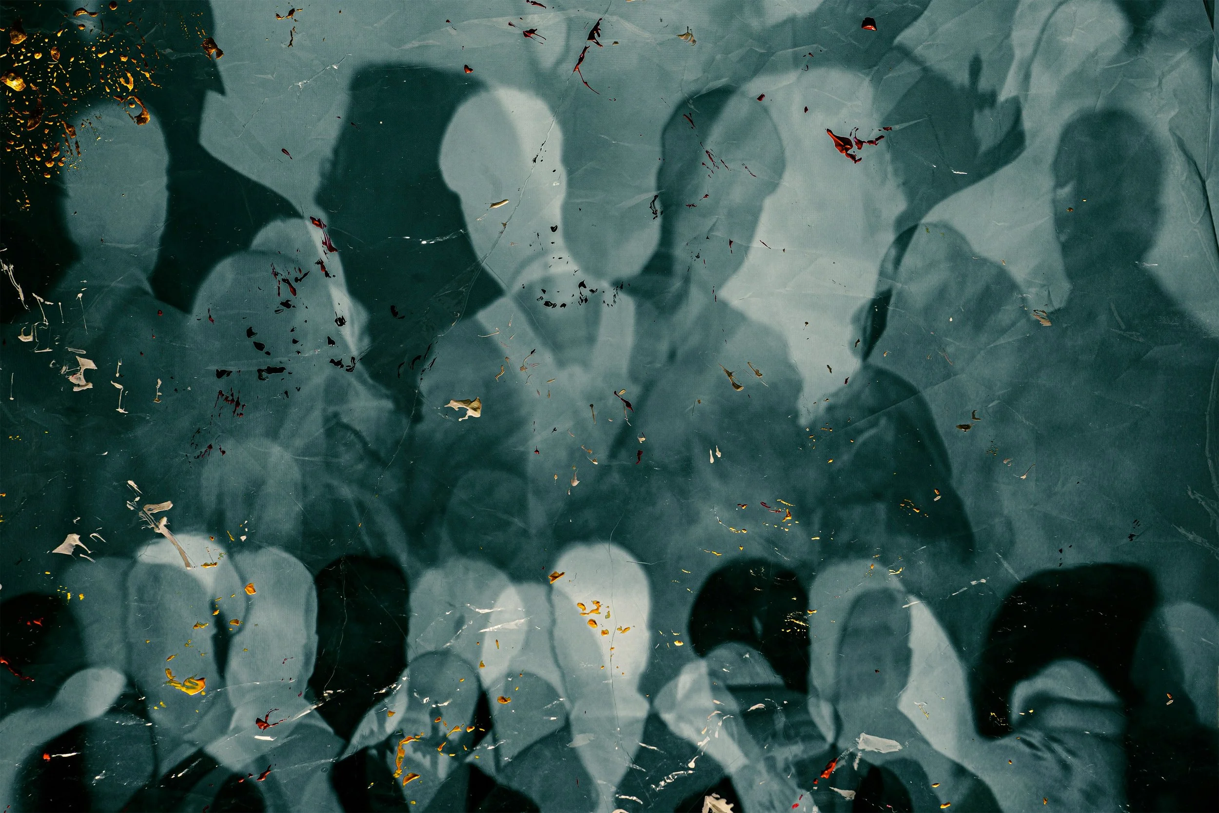 Silhouettes of five people holding umbrellas casting shadows on a wet surface with scattered colored leaves.