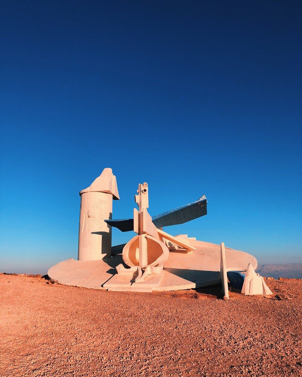  a modern statue sits in the middle of the Negev Desert 