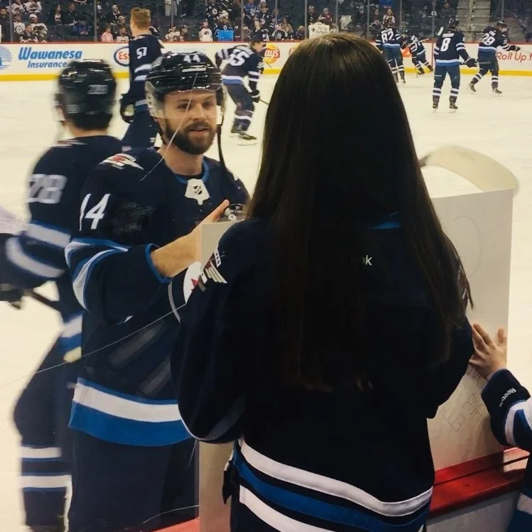 Pictured: Josh takes a moment during warm-up to say hi to Dream Kid Ava and her sister, Ella.