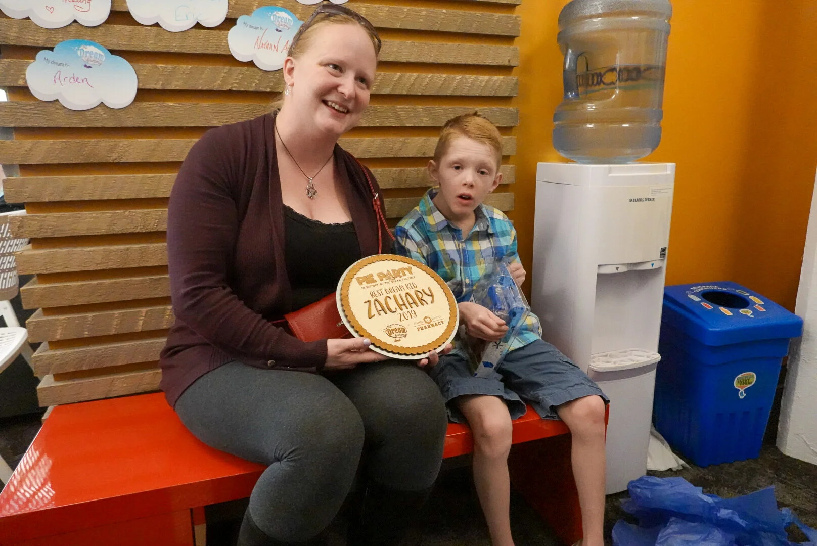 Pictured: Dream Kid Zachary being presented with a small gift from our friends at Exchange District Pharmacy - nearly $9000 was raised for his dream come true!