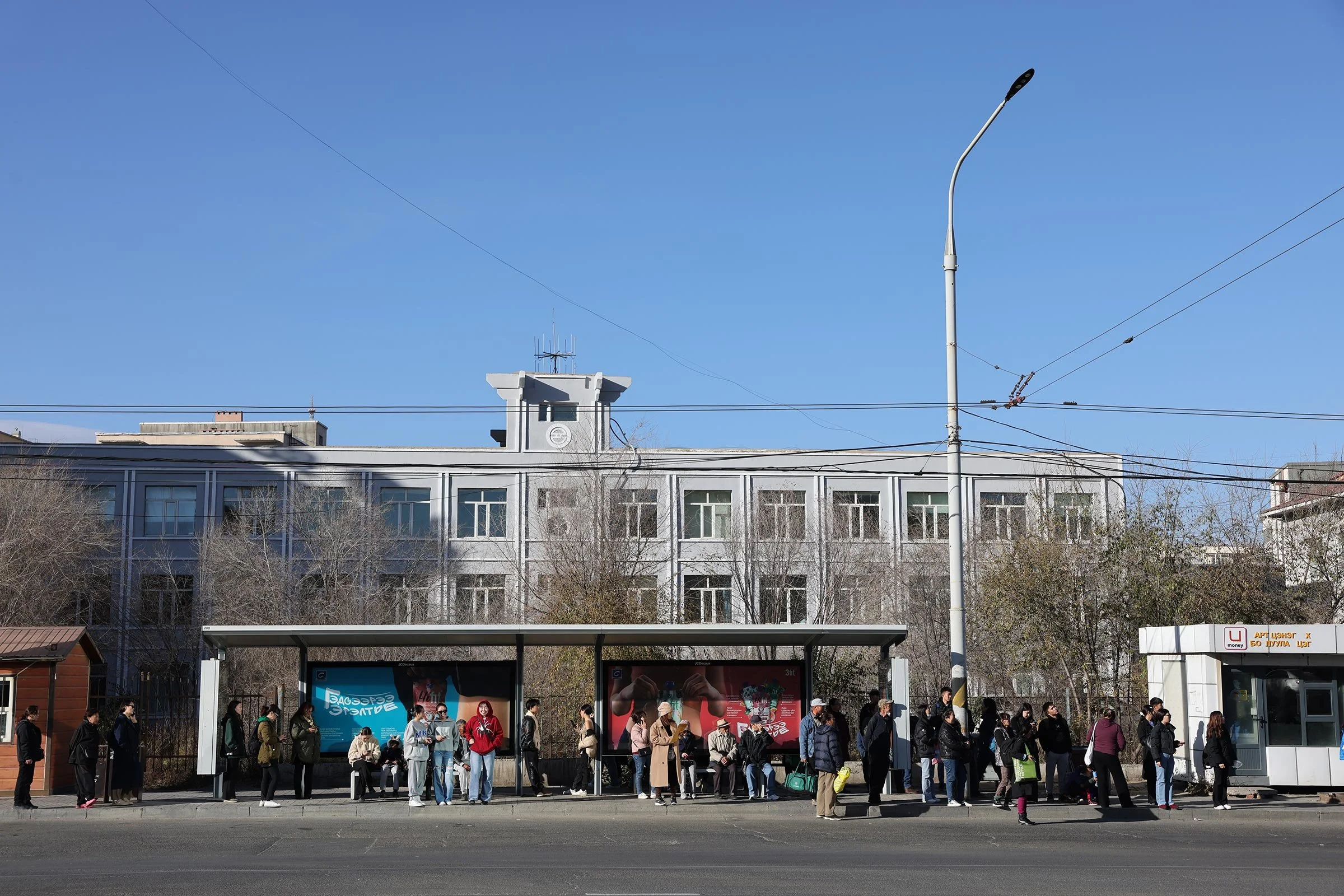 En busshållplats med väntande resenärer i Ulaanbaatar, Mongoliet
