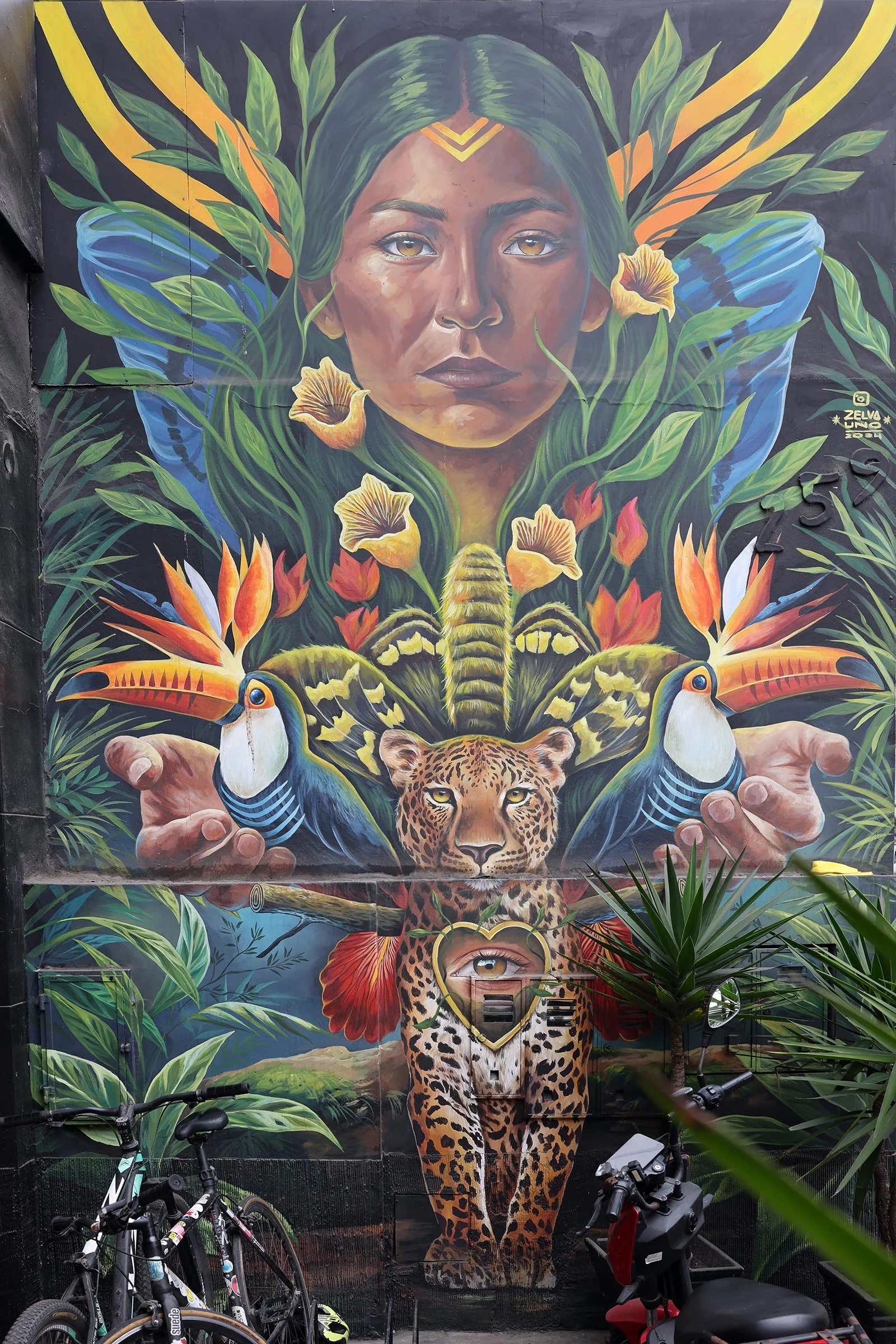 Streetart i form av tukaner, en jaguar och en kvinna i ett djungellandskap, Lima, Peru