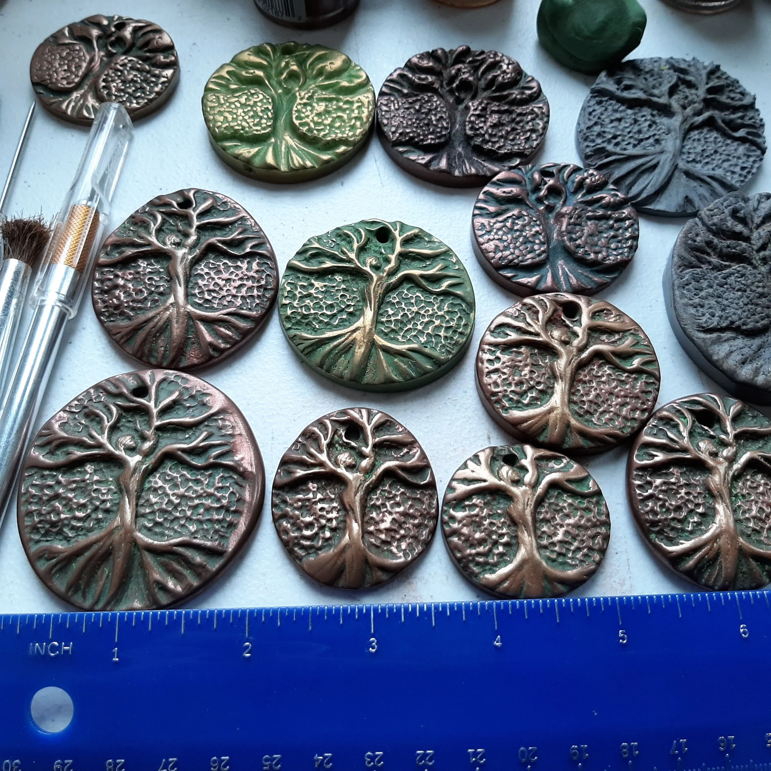 My initial pendants are trimmed with a circular cutter, but I found that I preferred the untrimmed ones. At the Art Market three days later, I sold all of the untrimmed ones and none of the trimmed ones. Lesson learned!