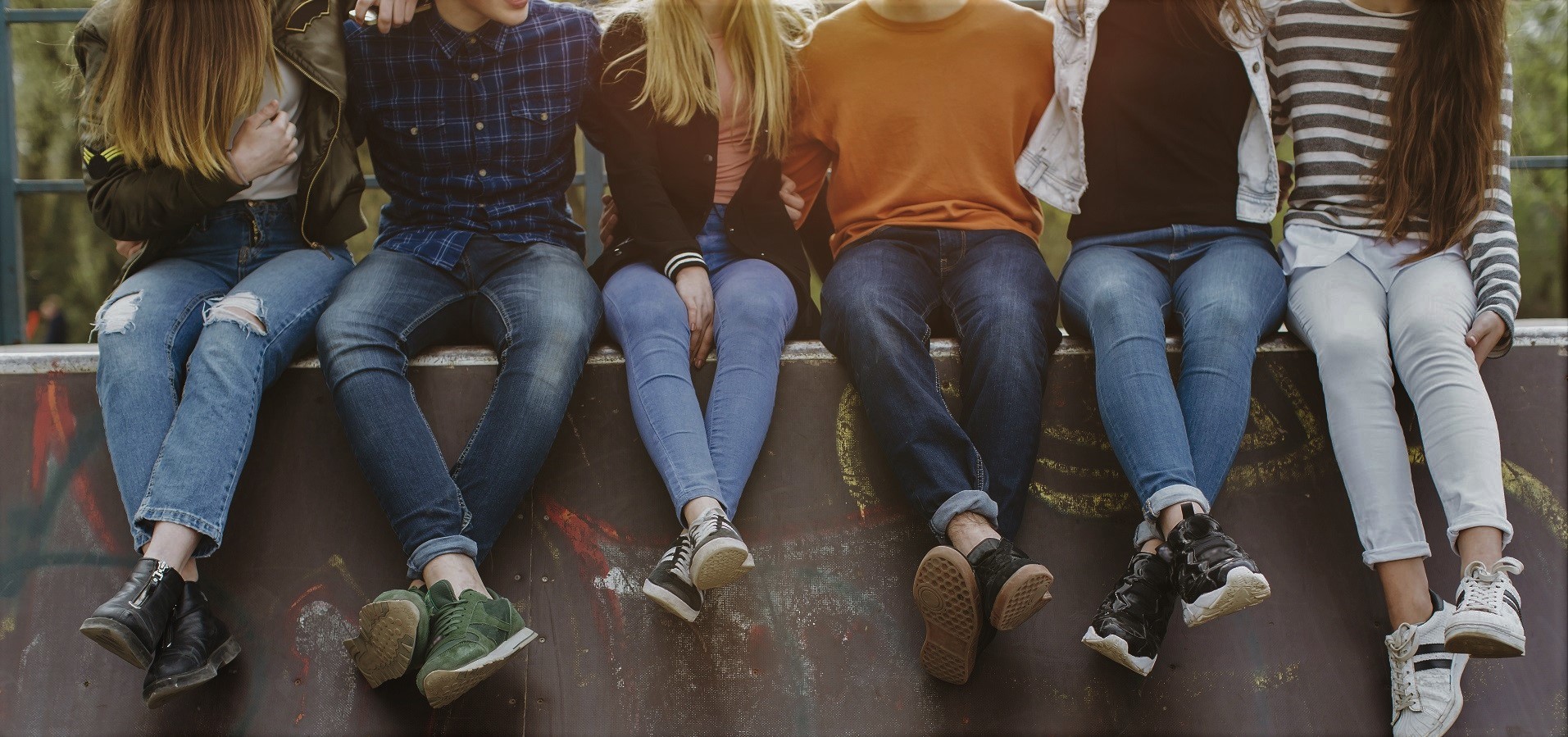 Teens sitting on wall.jpeg