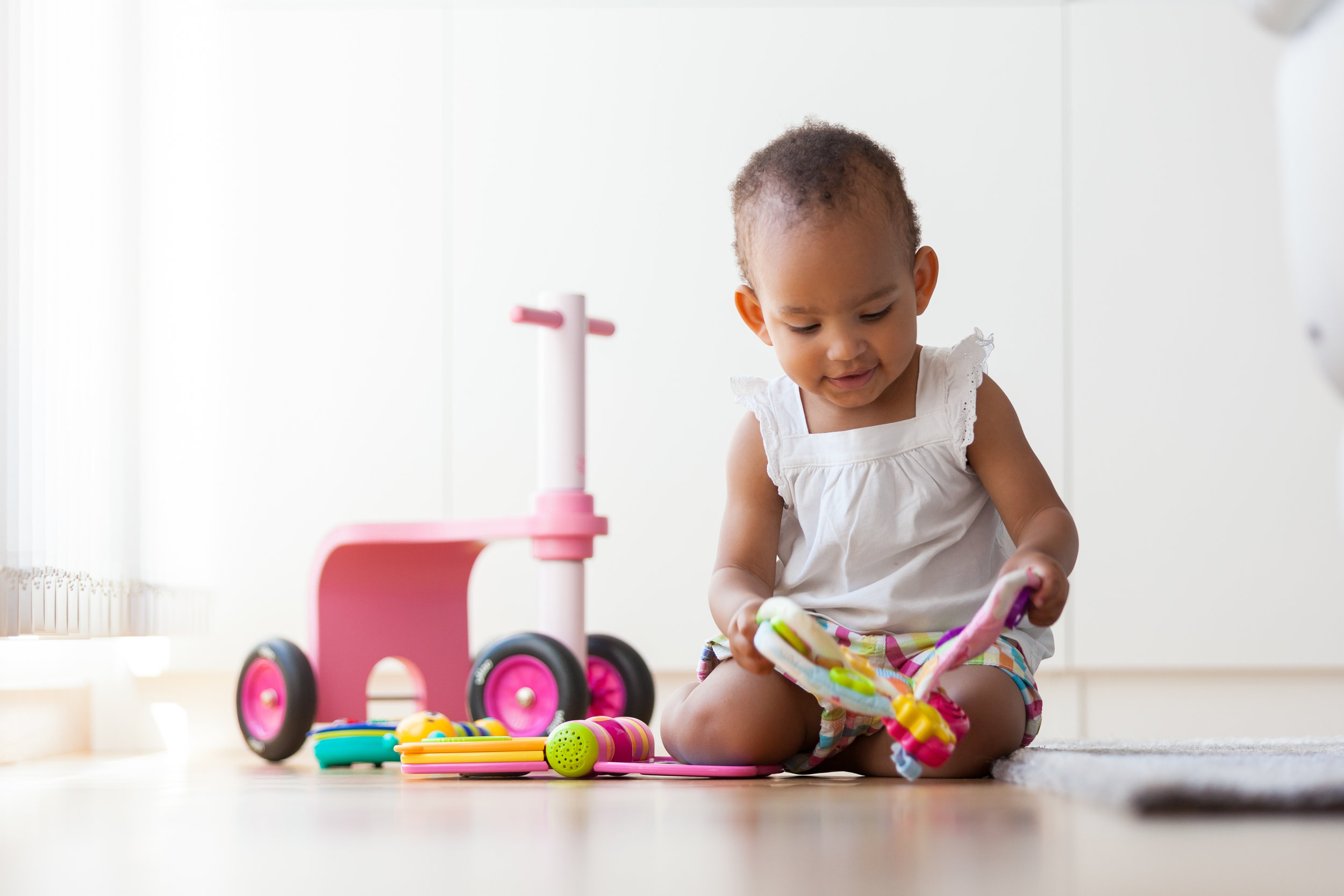About - Toddler_with_toys.jpeg