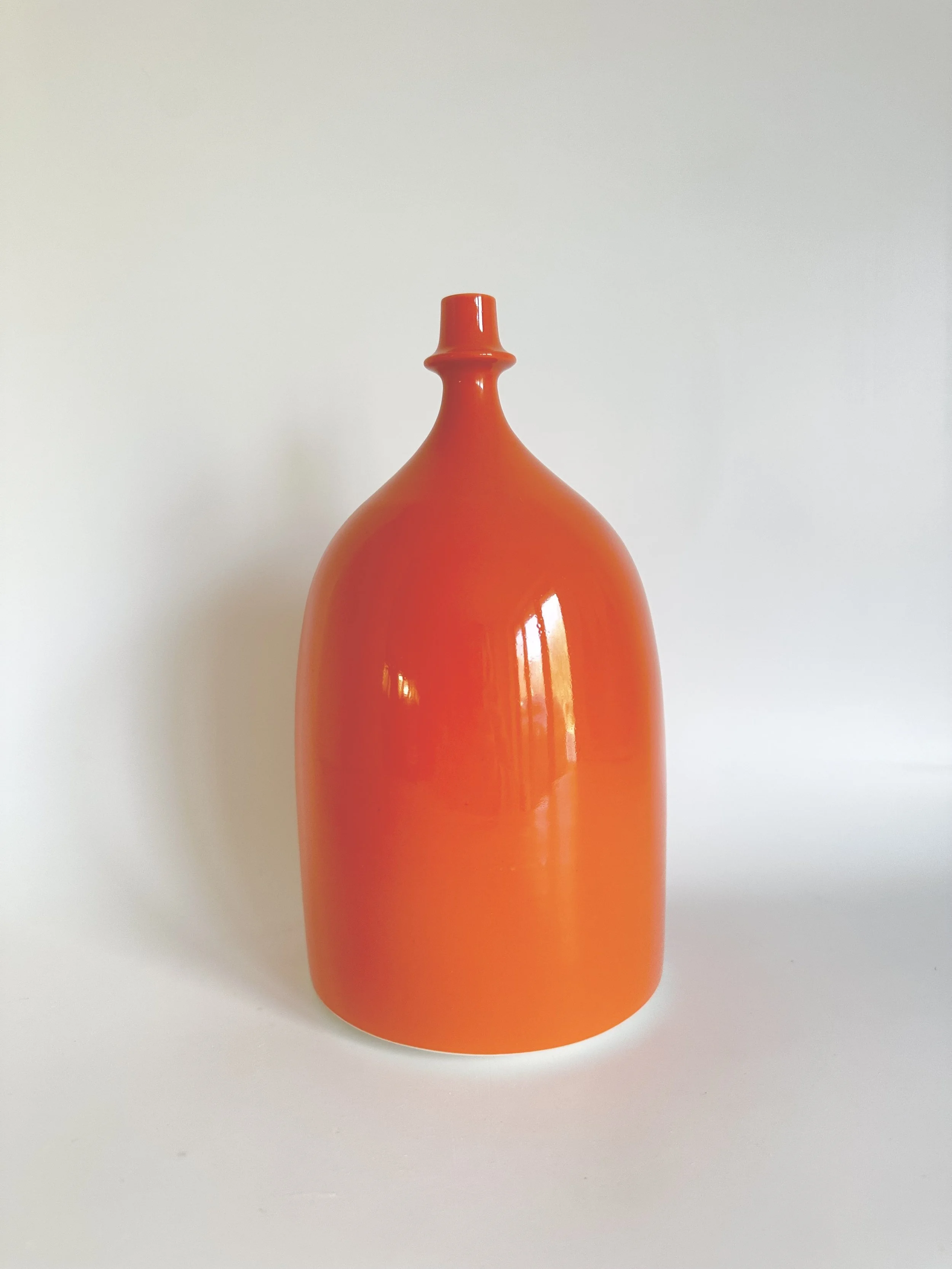 small bottle shiny orange experimental neck