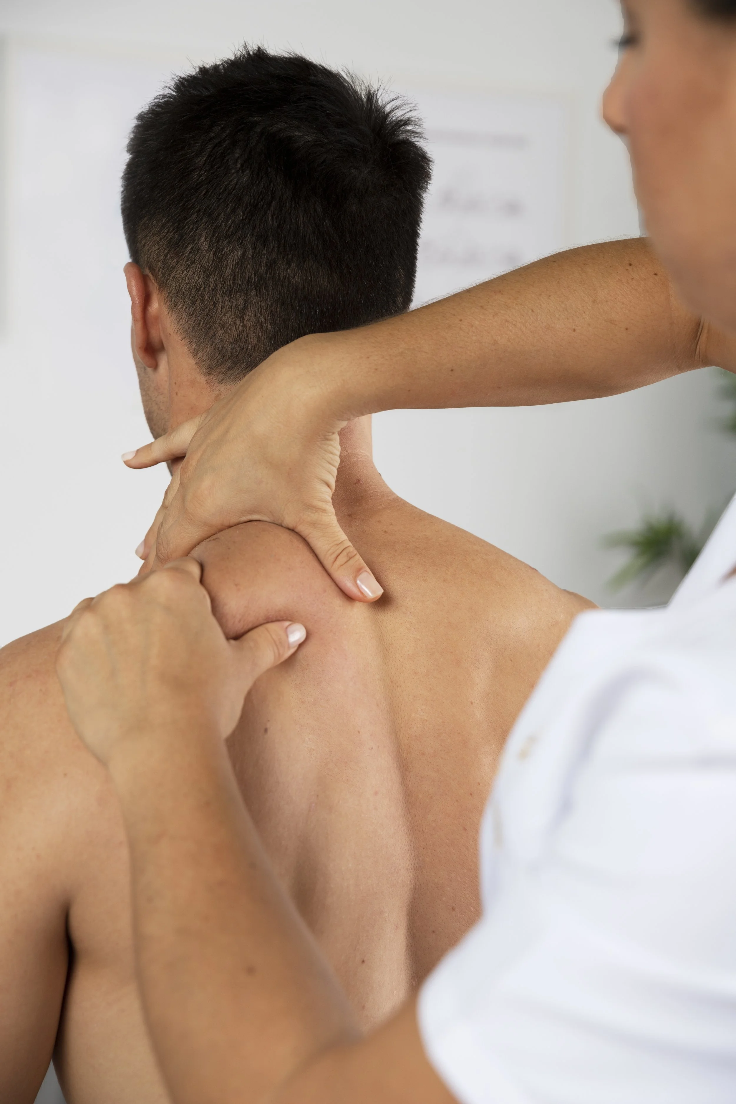 physiotherapist-performing-therapeutic-massage-male-client.jpg