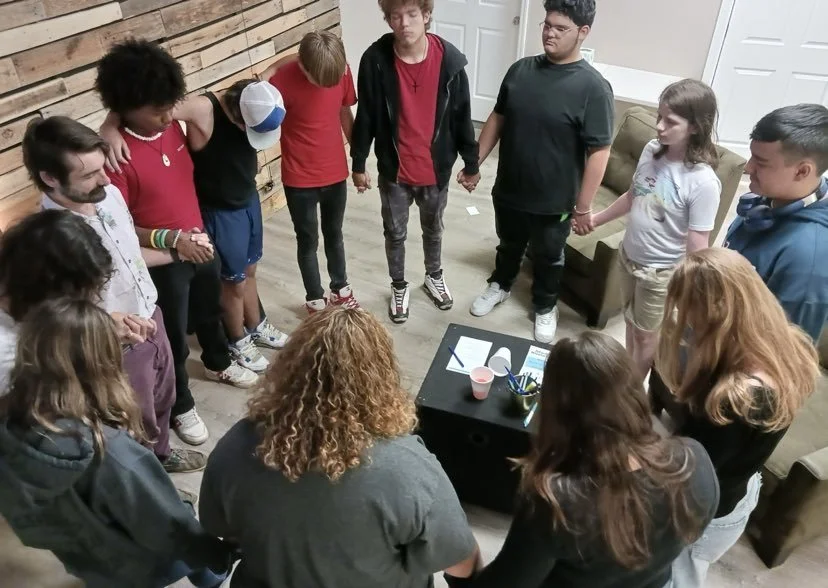 website 16 group picture praying students.jpeg